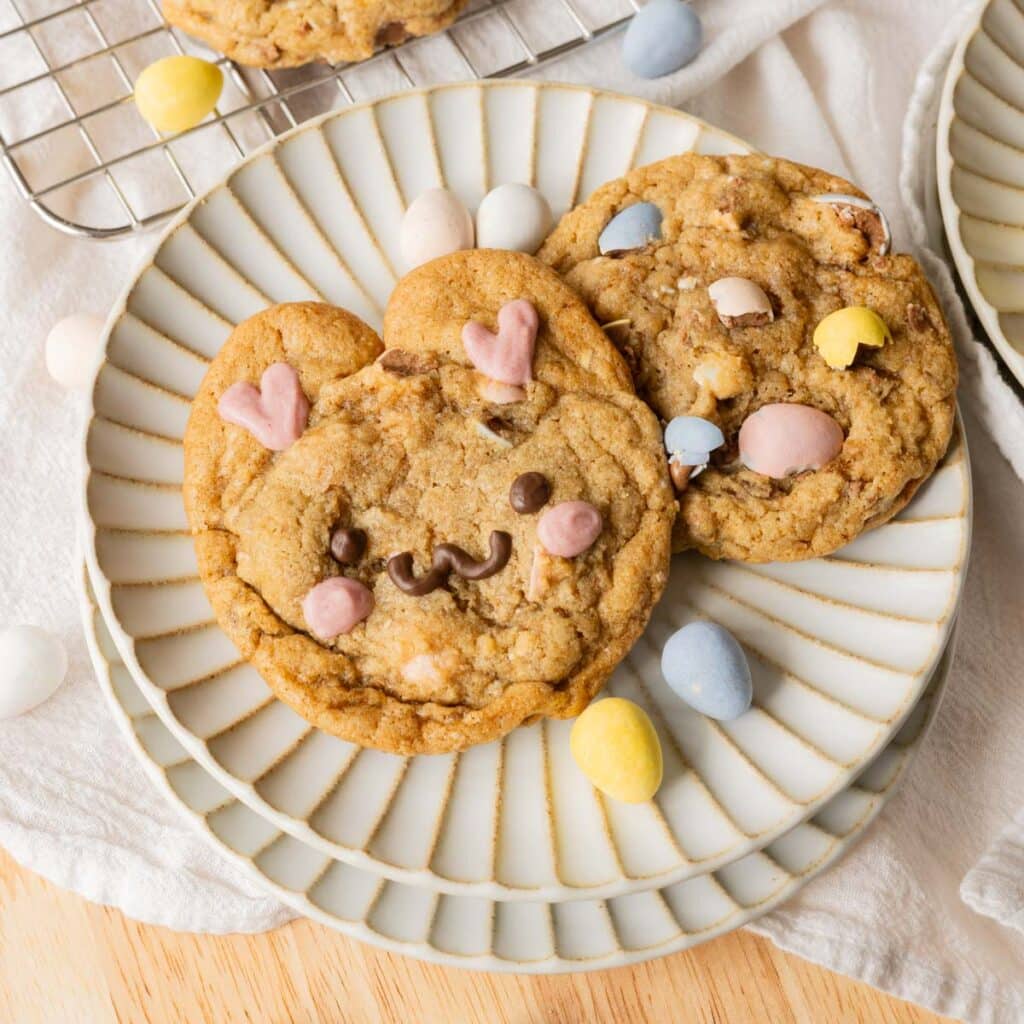 Cute cadbury egg cookies on a white plate.