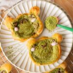 Frog matcha danishes on a plate.