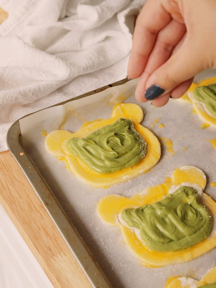 Sprinkling sugar on top of puff pastry.