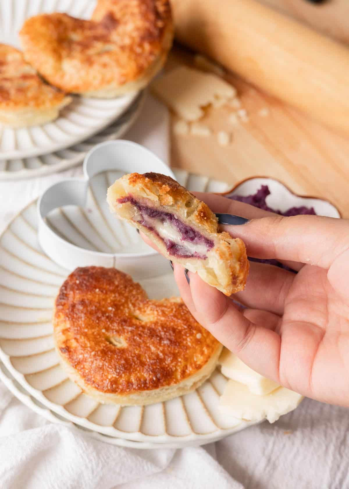 Holding an ube cheese hand pie.