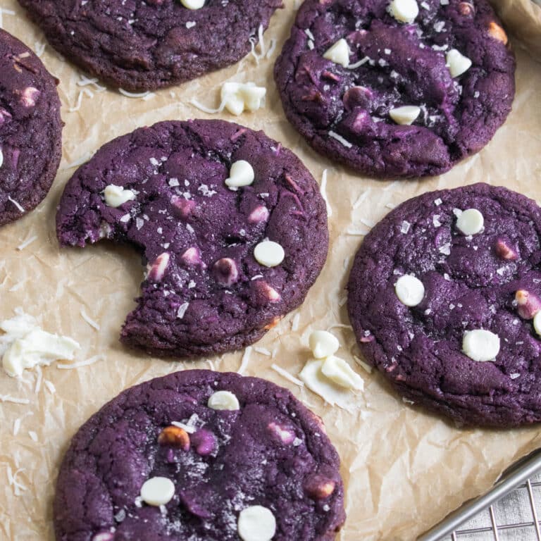 thin and chewy ube cookies with white chocolate chips and coconut