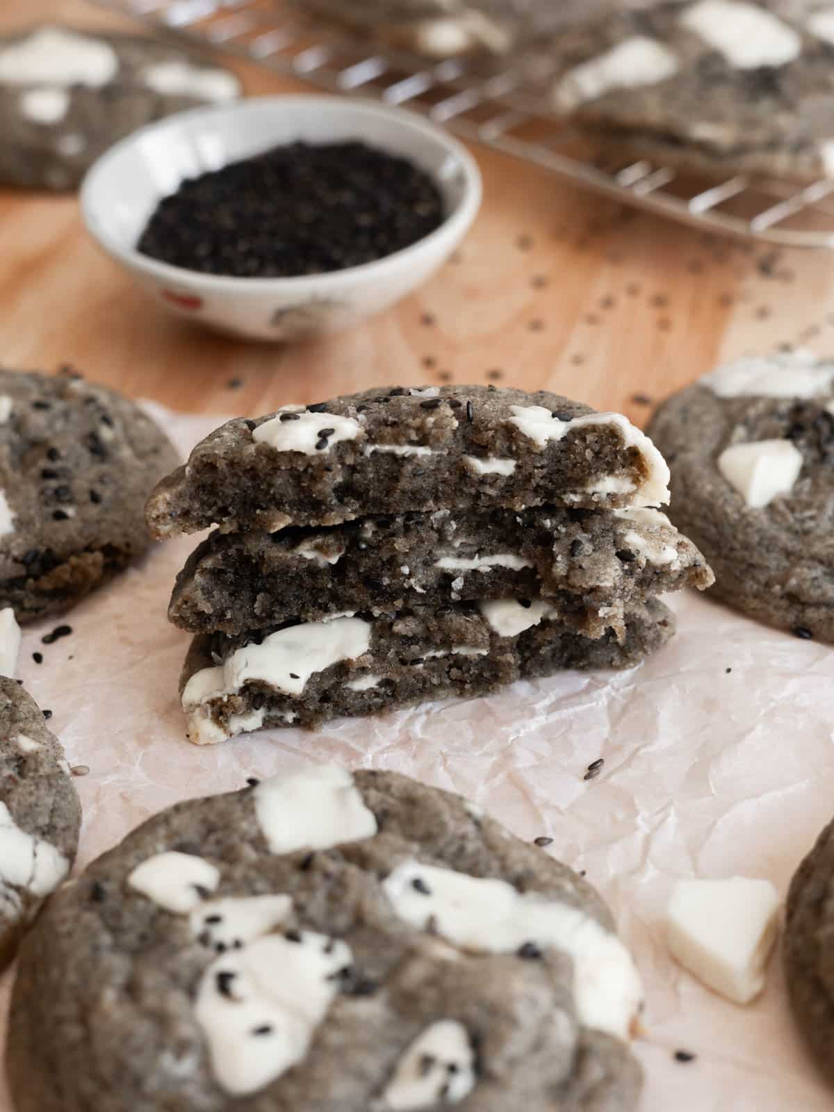 Cross section of black sesame cookies, stacked on top of one another.