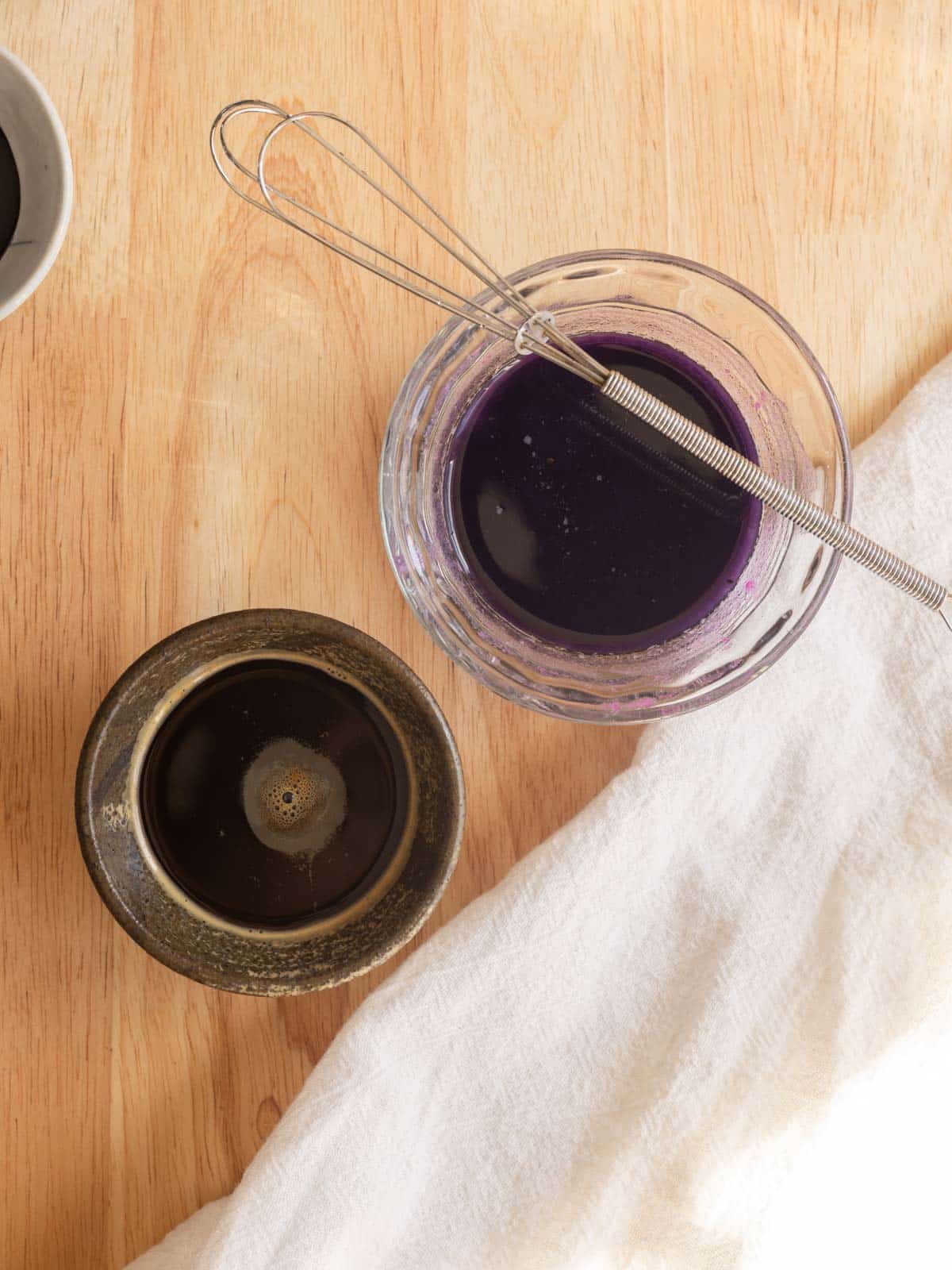 Instant espresso and dissolved ube halaya in two small bowls.