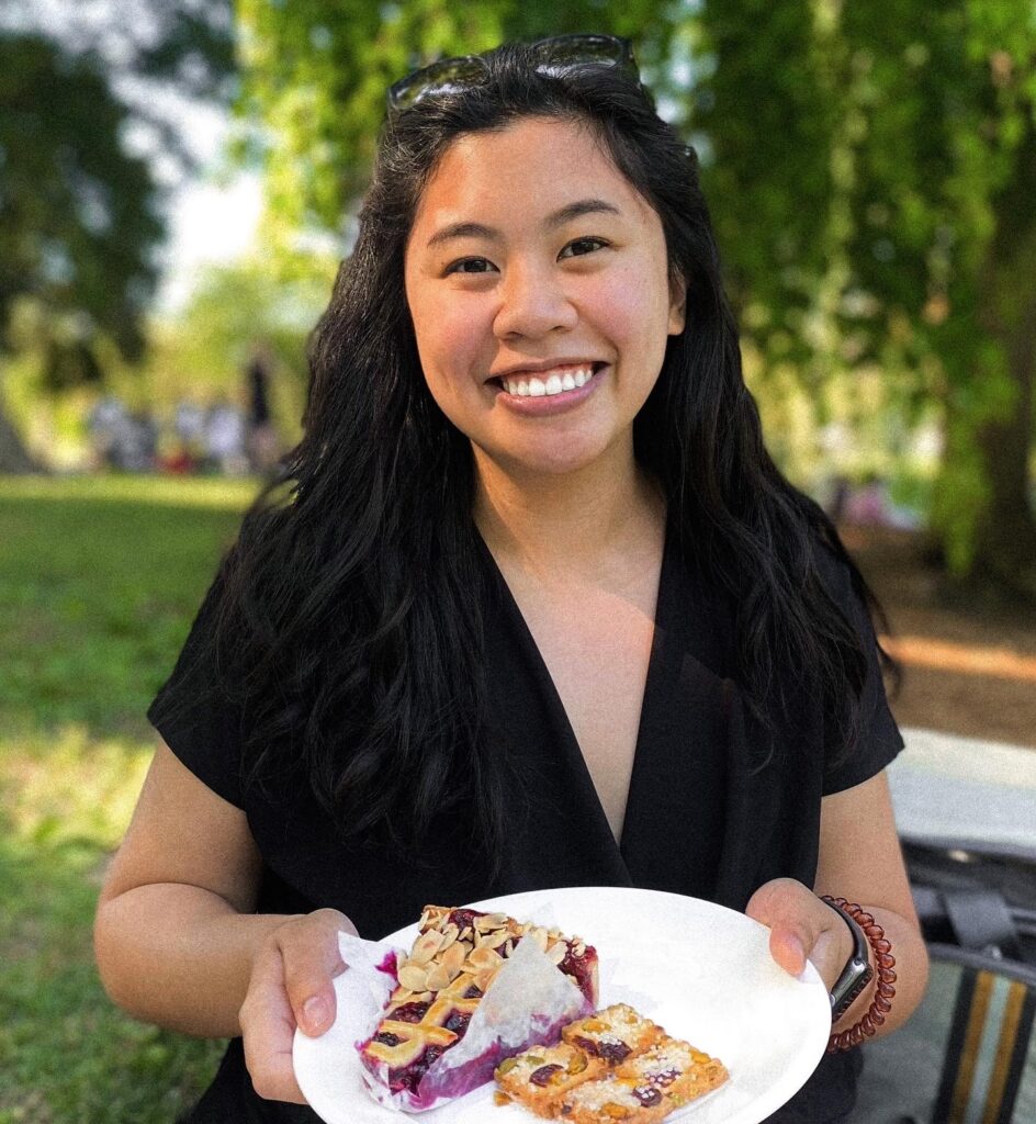 Picture of Bianca Fernandez holding a plate of dessert.