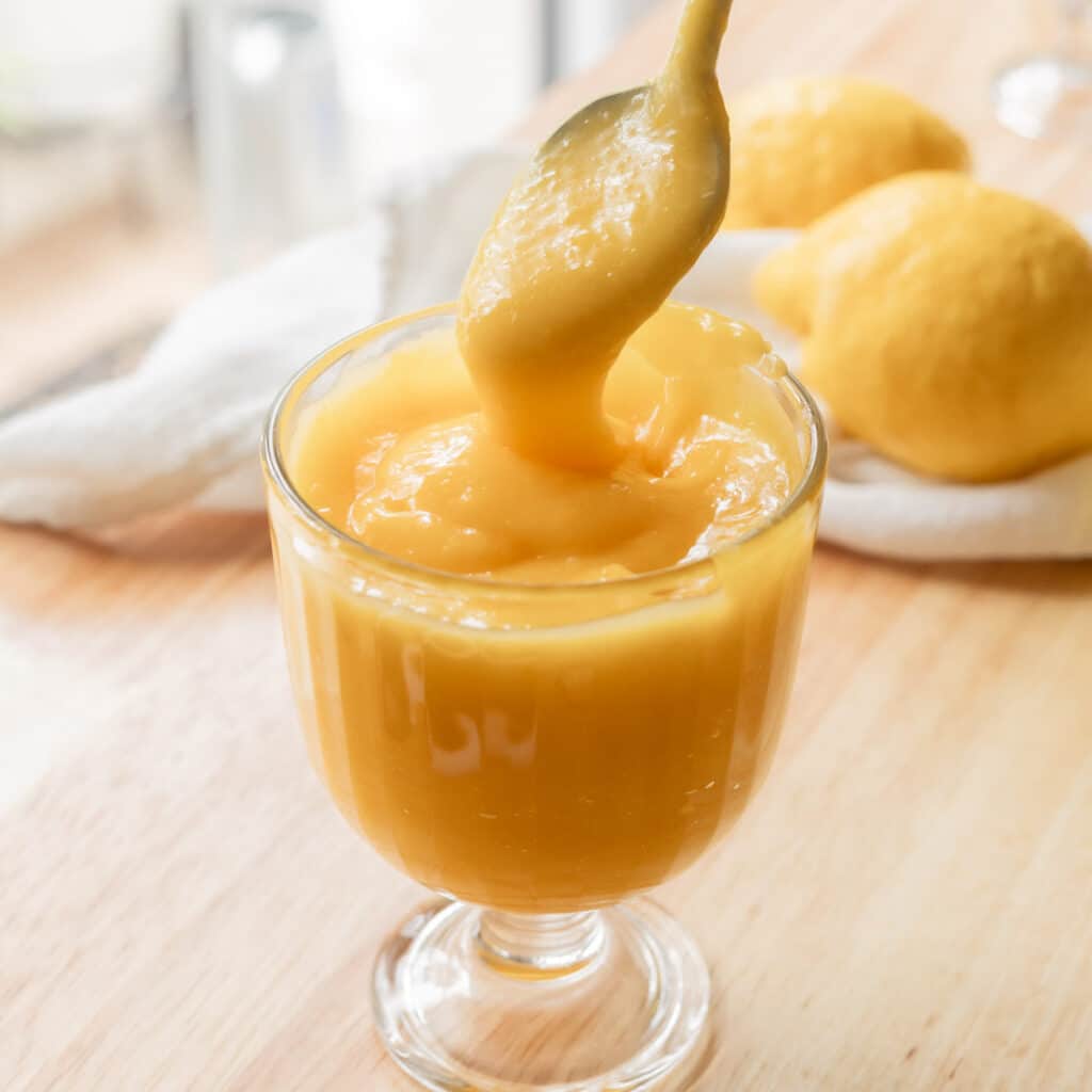 Lemon curd in glass serving cup.