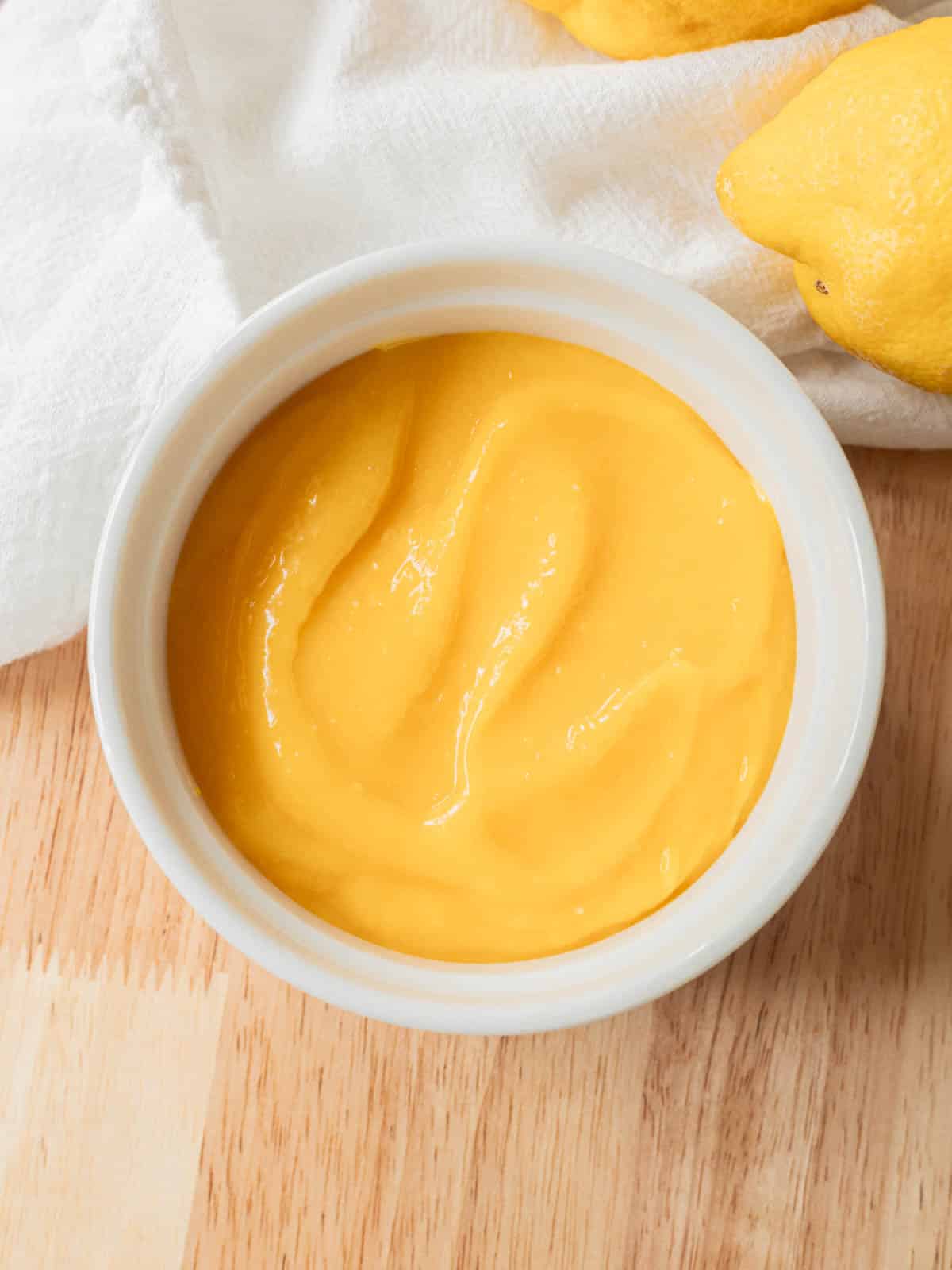 Lemon curd in white ramekin.