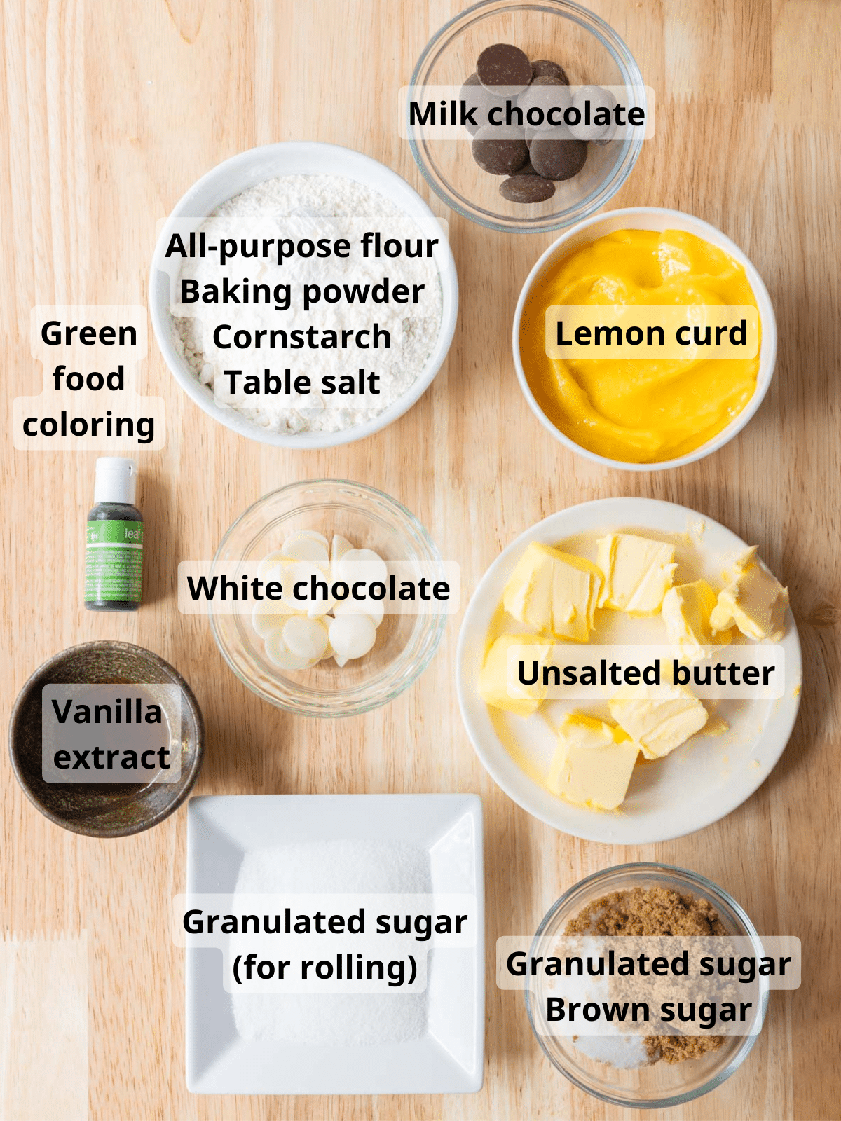 Labeled ingredients laid out on a wooden backdrop.