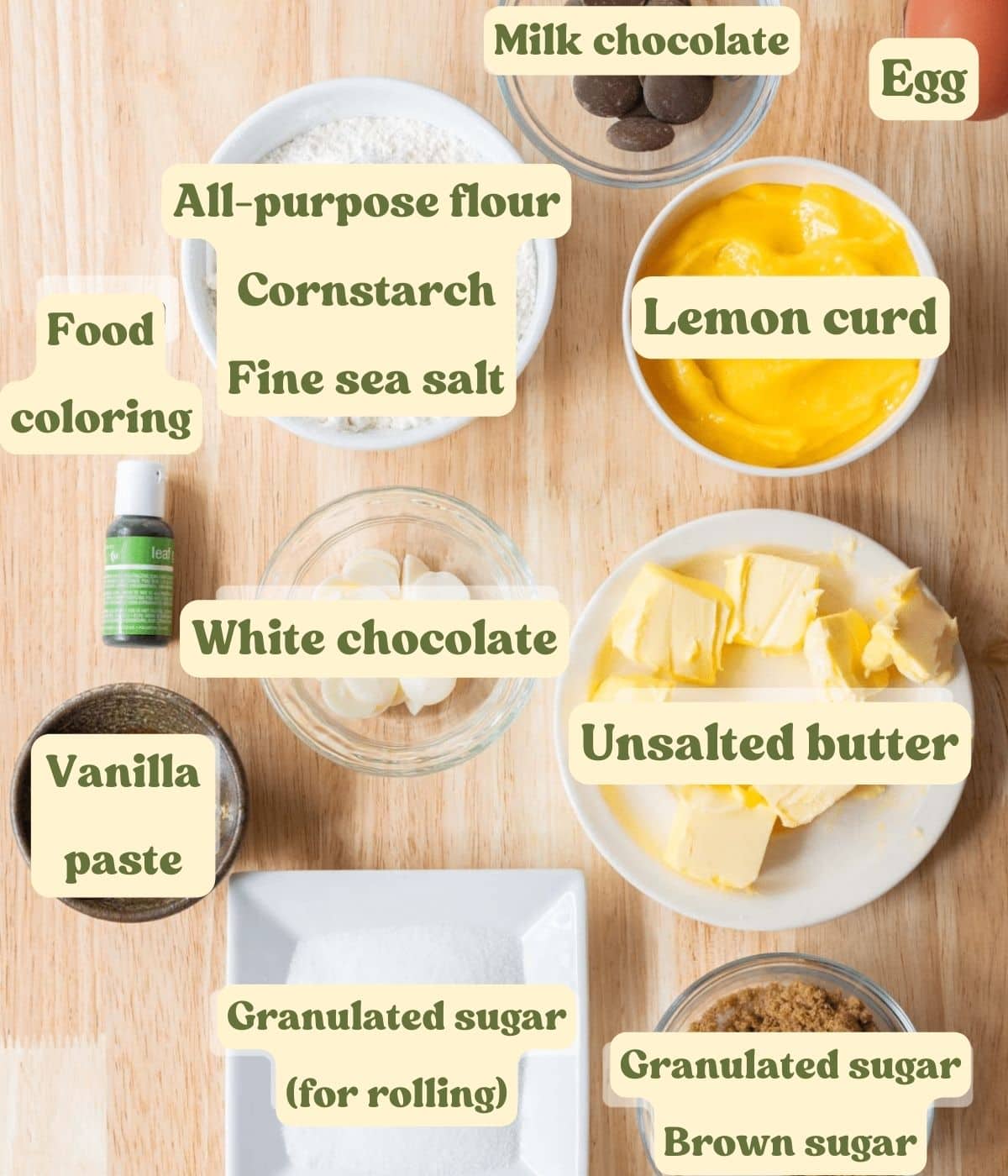 Lemon thumbprint cookie labeled ingredients laid out on a wooden table.
