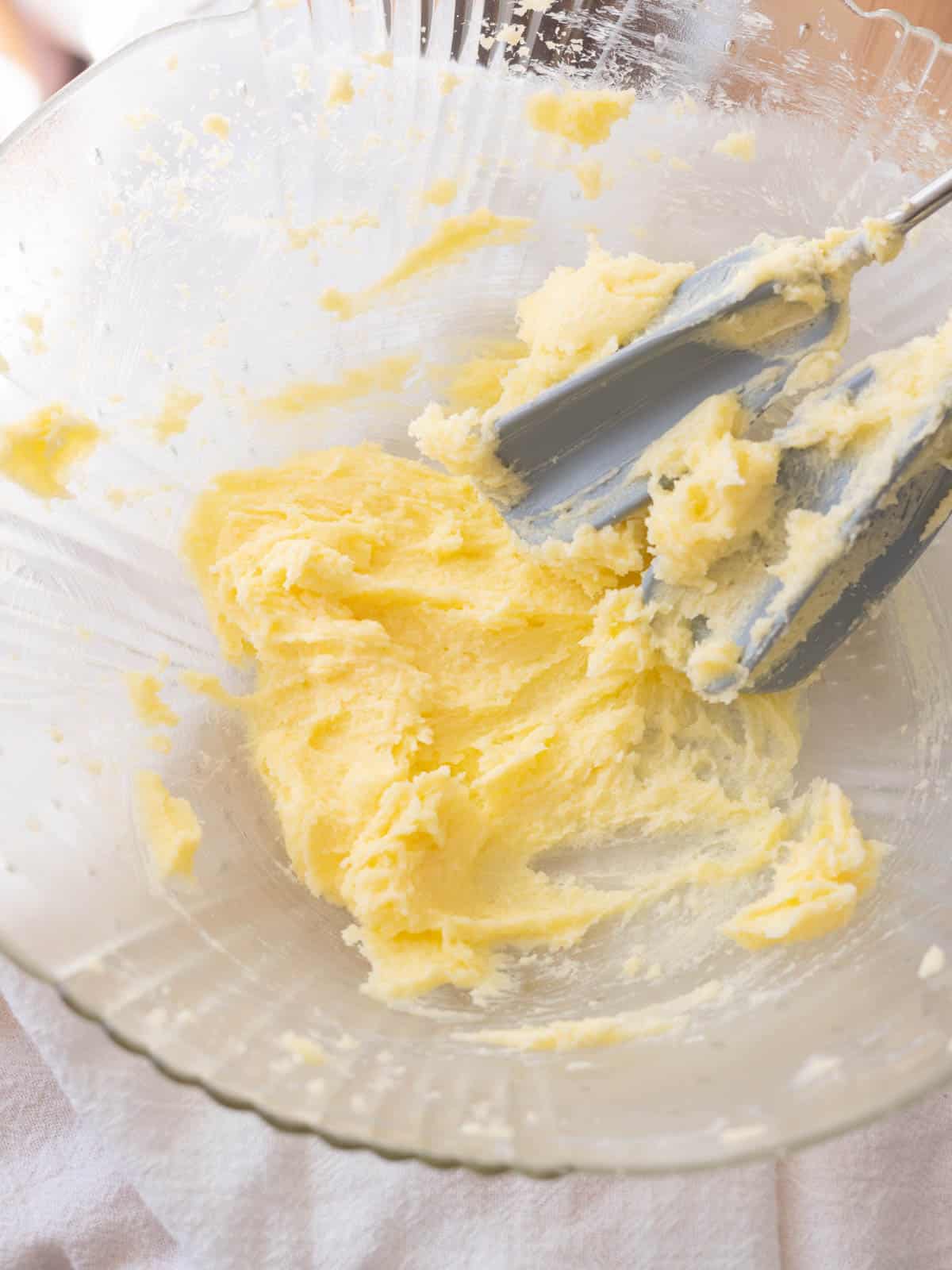 Lightly creamed butter and sugar in glass mixing bowl.