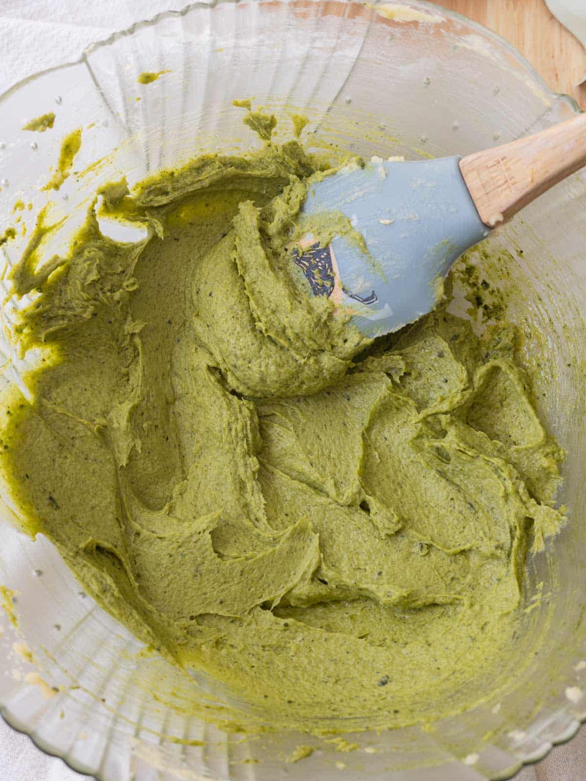 Mixing bowl with butter, sugar, egg vanilla, and matcha mixed together, which created a vibrant green batter.