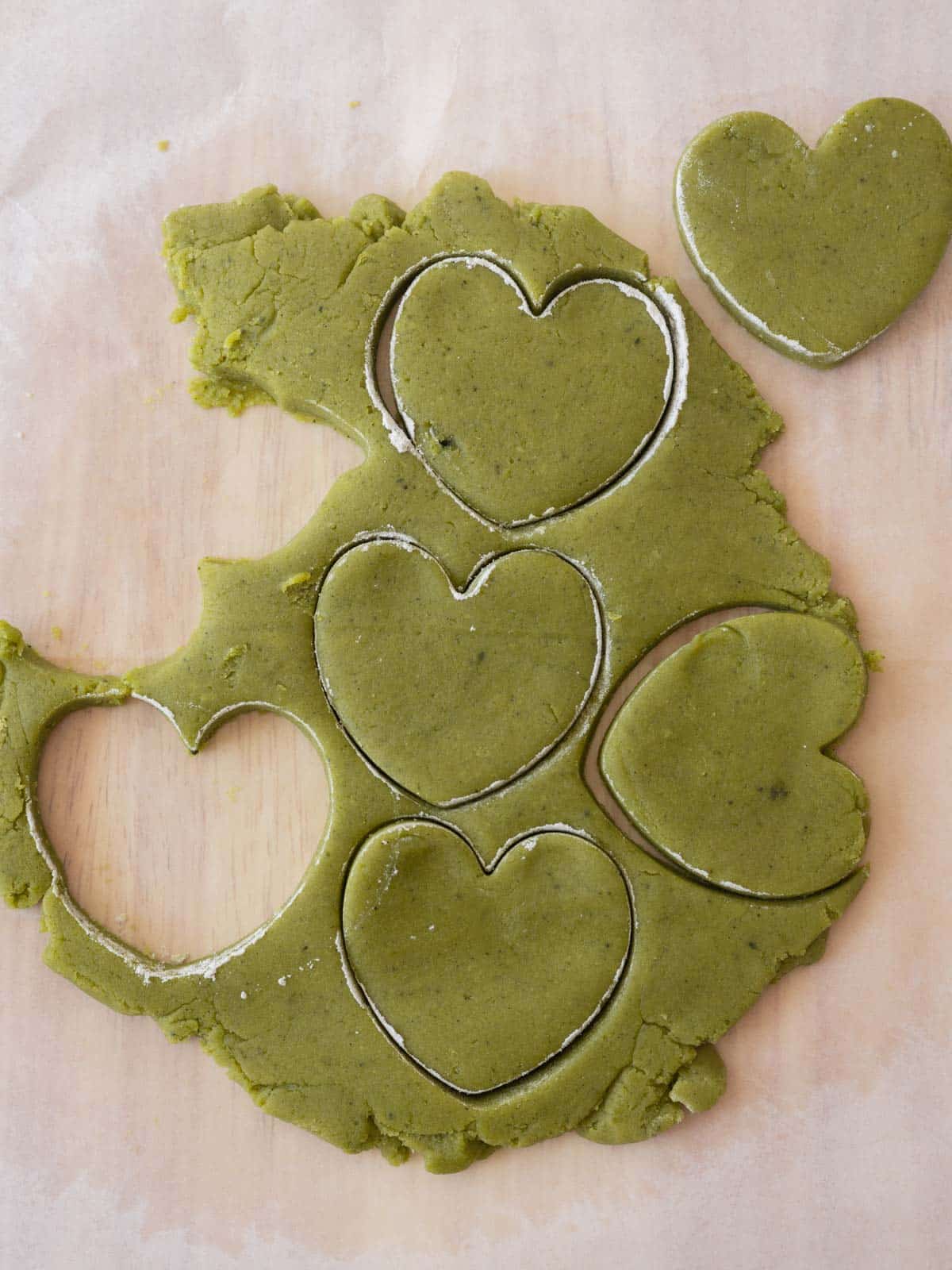 Cut out hearts in rolled out matcha cookie dough.