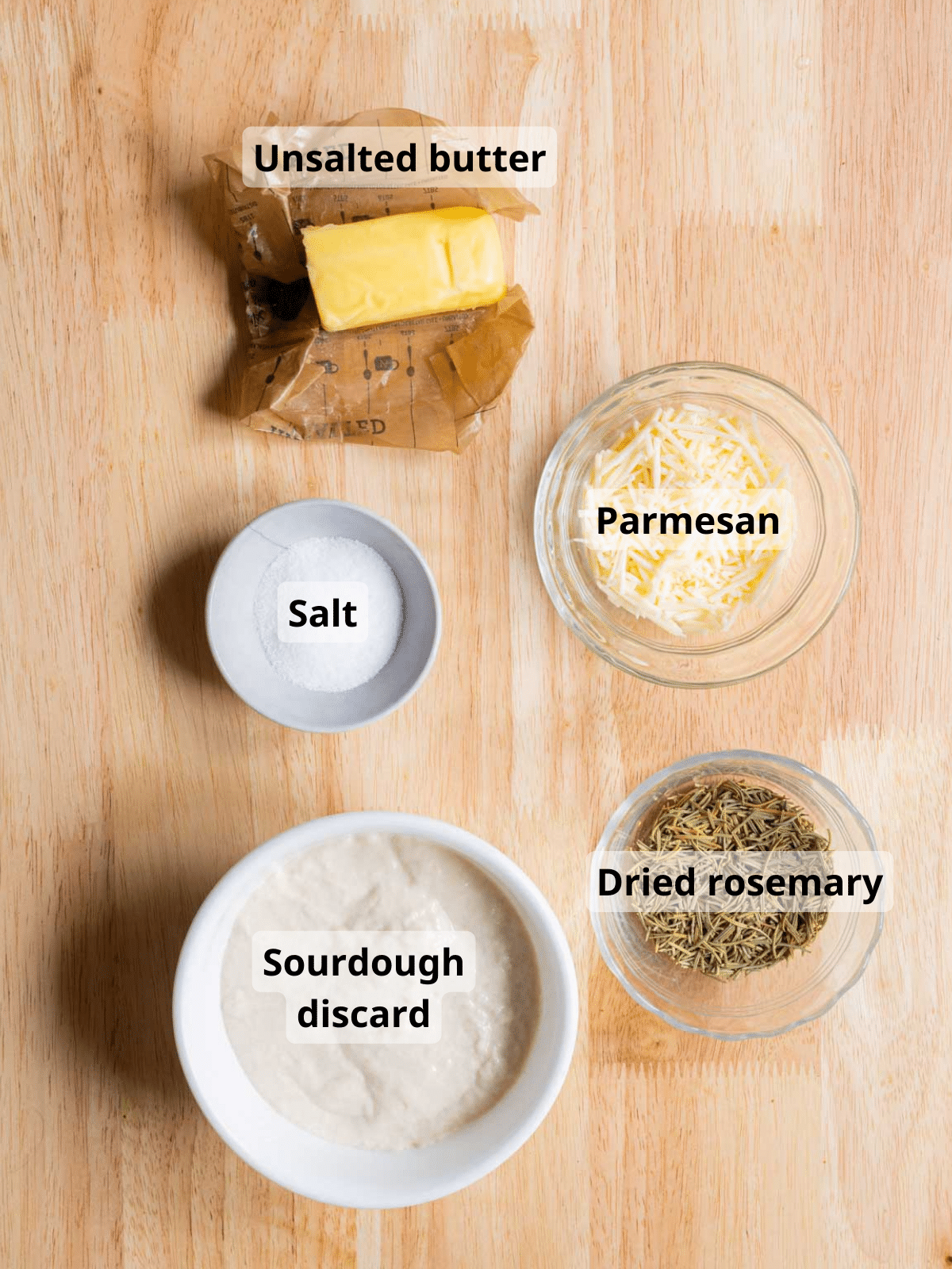 Sourdough cracker ingredients labelled on a wooden backdrop.