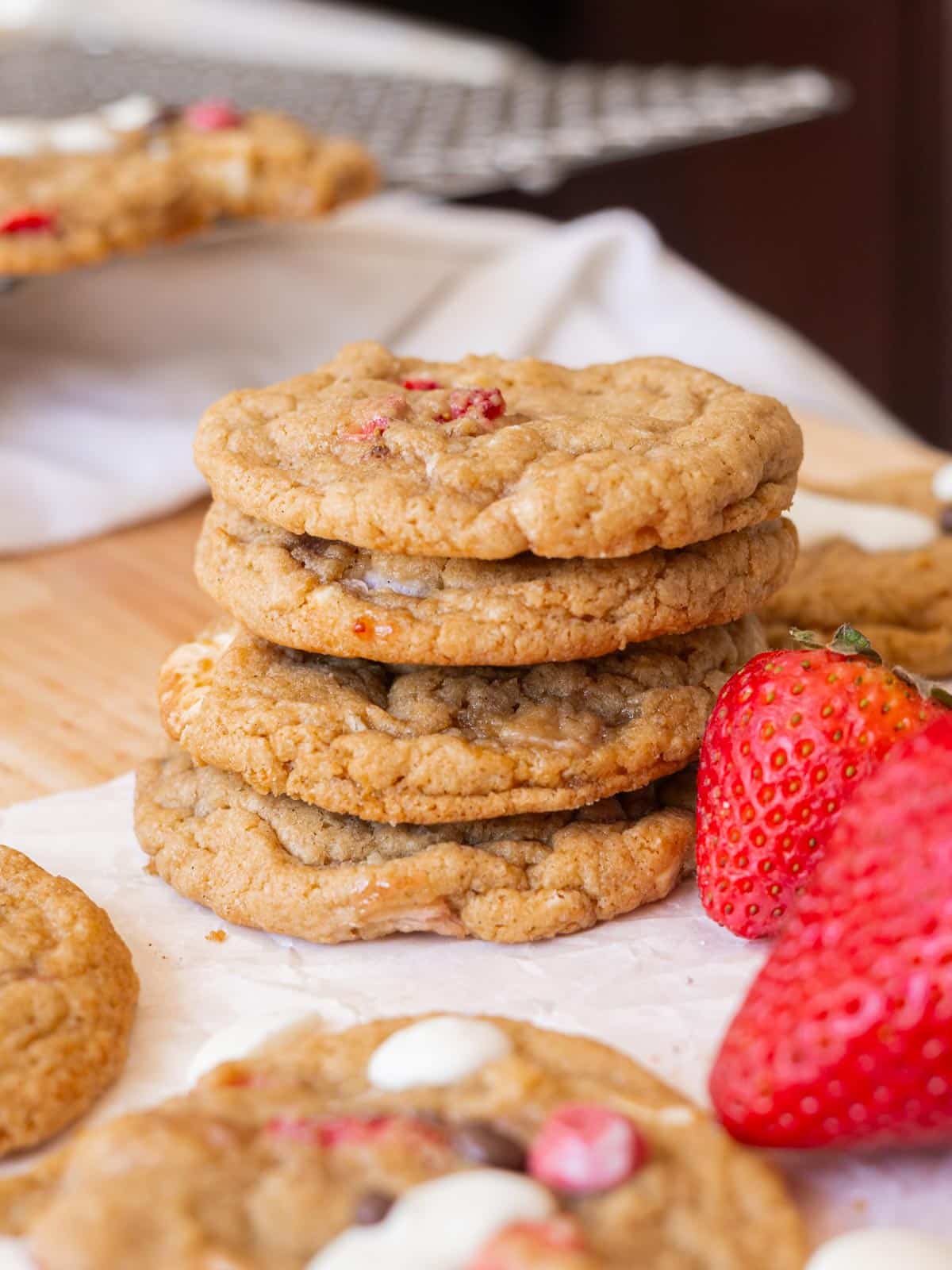 White chocolate strawberry cookies stacked on top of one another.