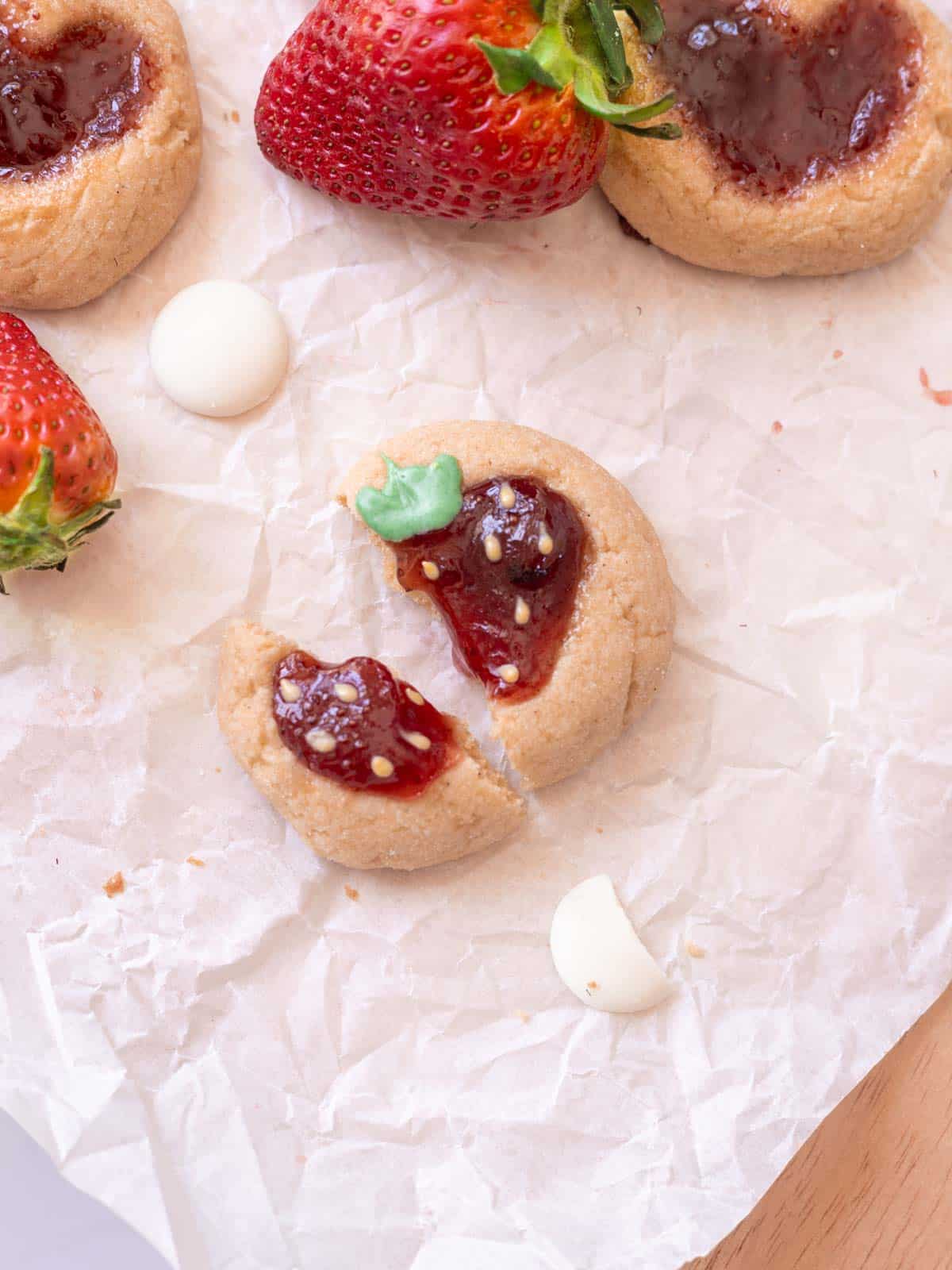 Strawberry thumbprint cookie broken in half.