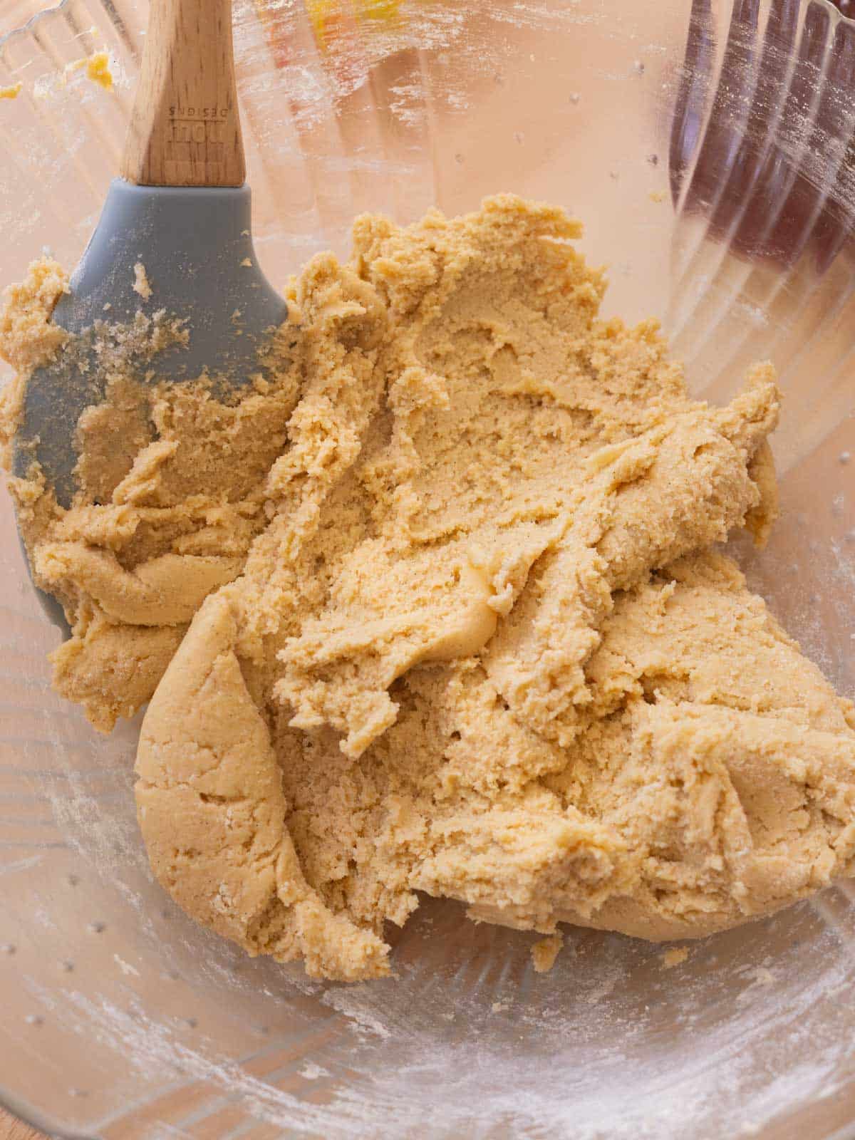 Cookie dough in glass mixing bowl ready to be scooped.