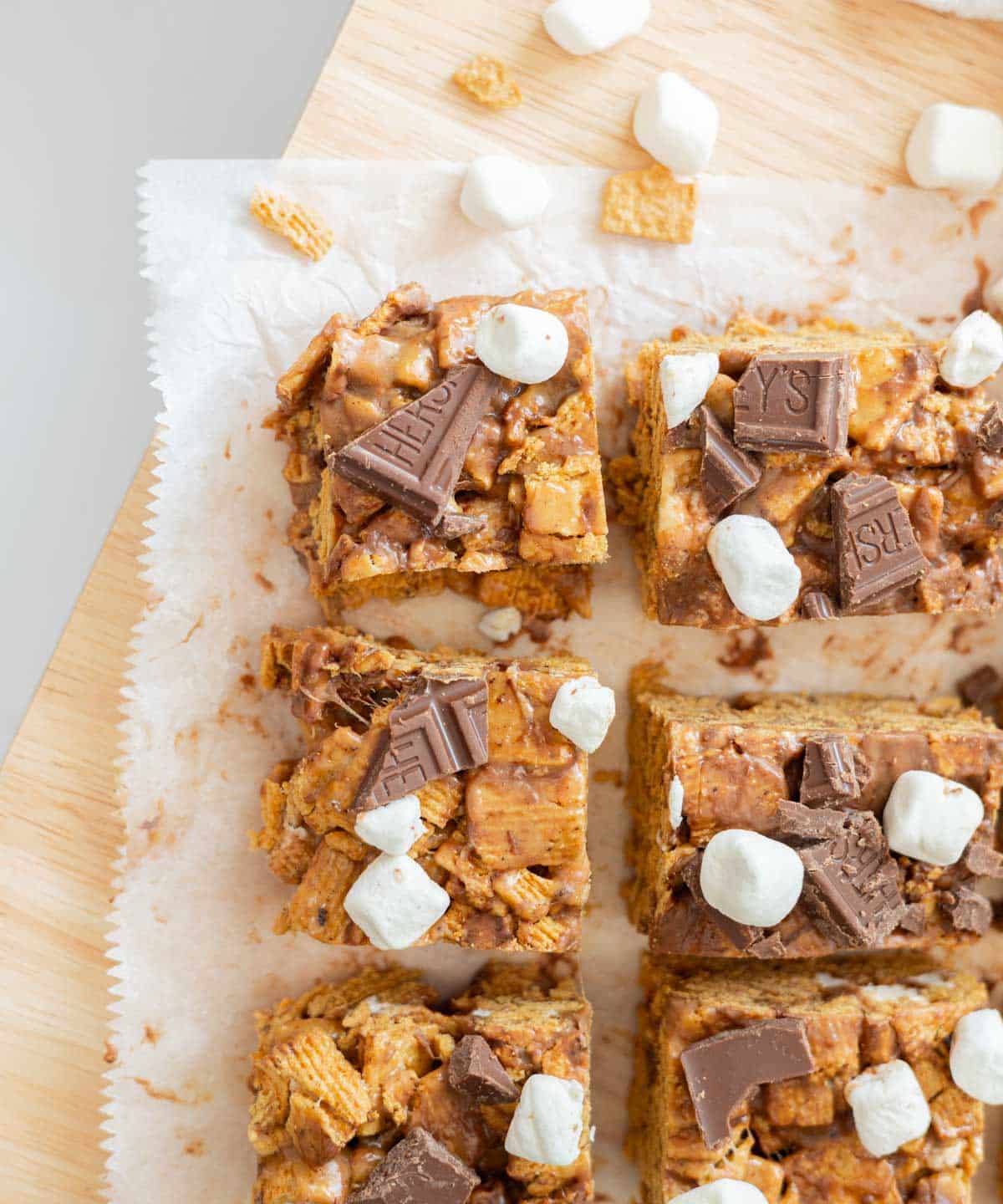 Birdseye view of s'mores bars cut into squares on parchment paper.