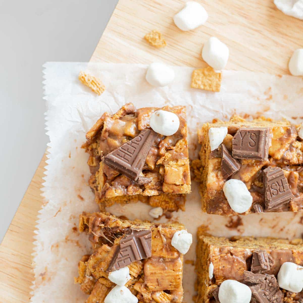 S'mores bars cut into squares on parchment paper.