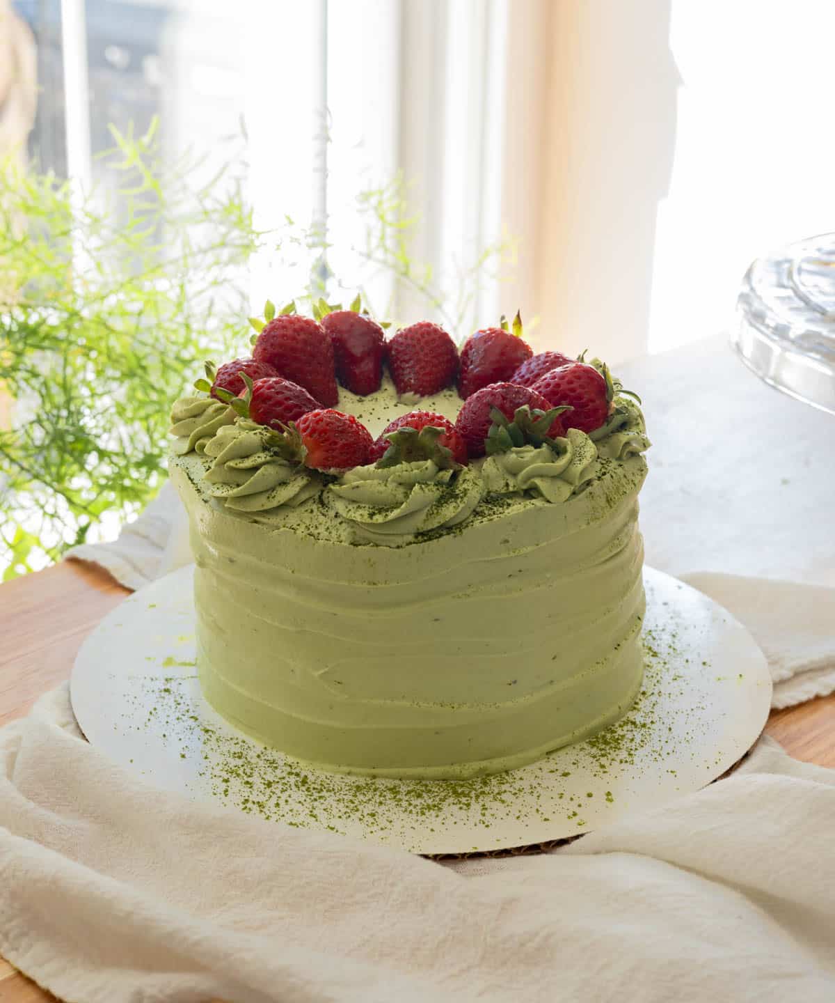 Frosted matcha cake with topped with strawberries; clicking on this image will open up to the recipe post.