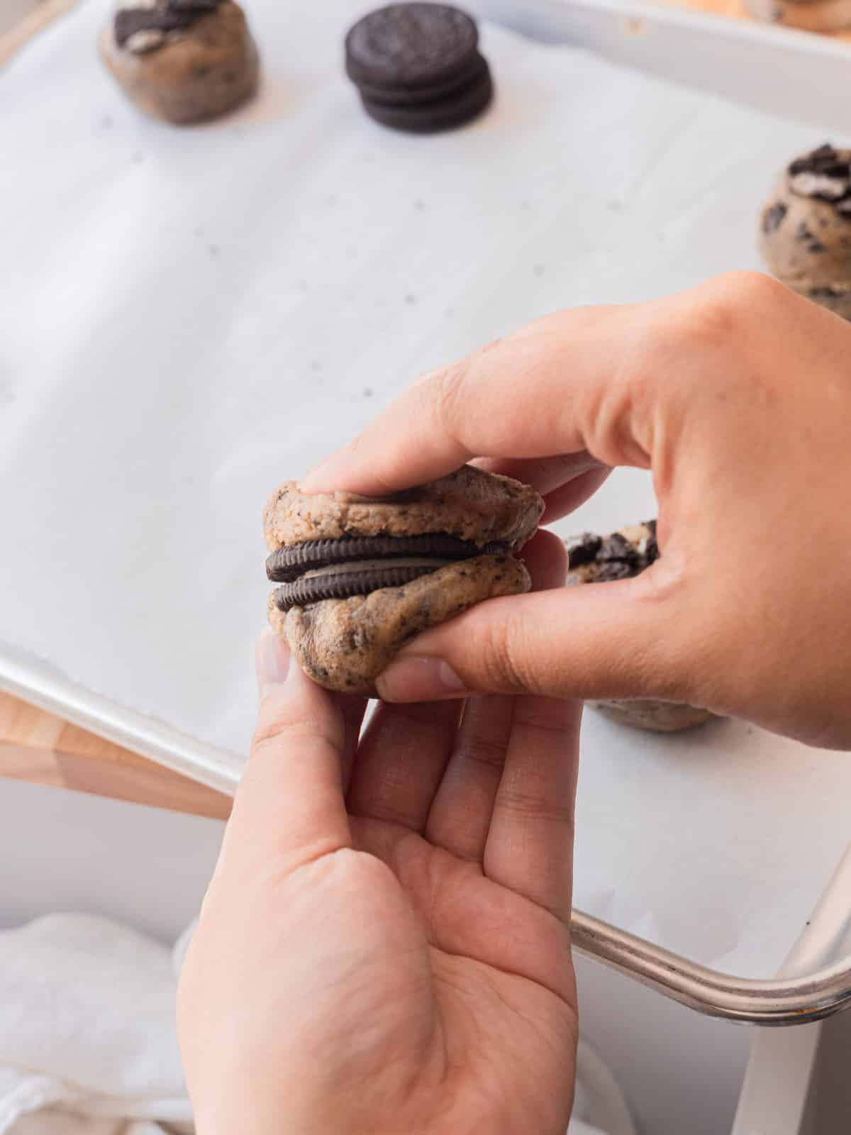 Wrapping an Oreo cookie with cookies and cream cookie dough.