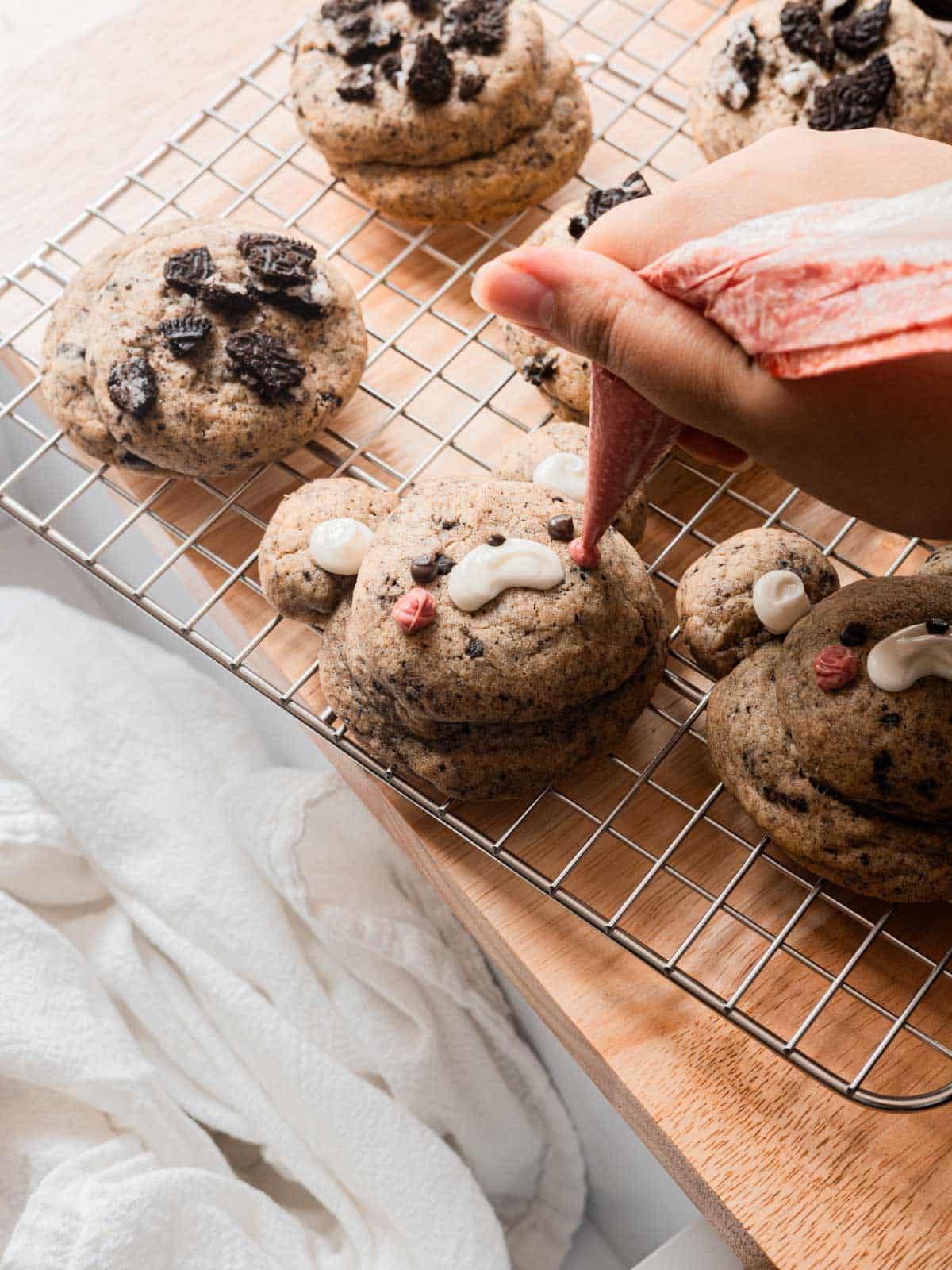 Decorating Oreo cookies with melted chocolates.