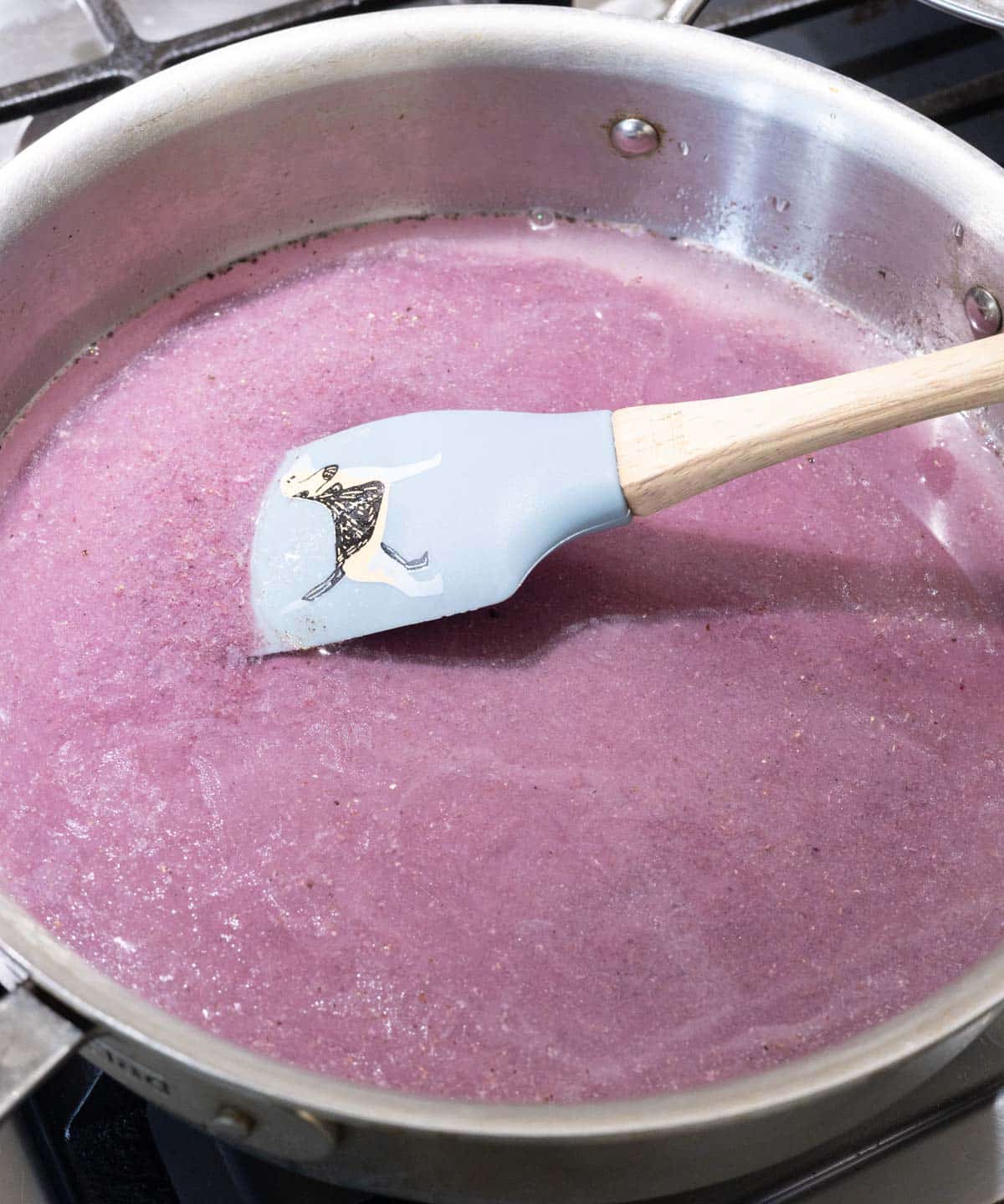 Water and rehydrated powder in a large stainless steel pan.