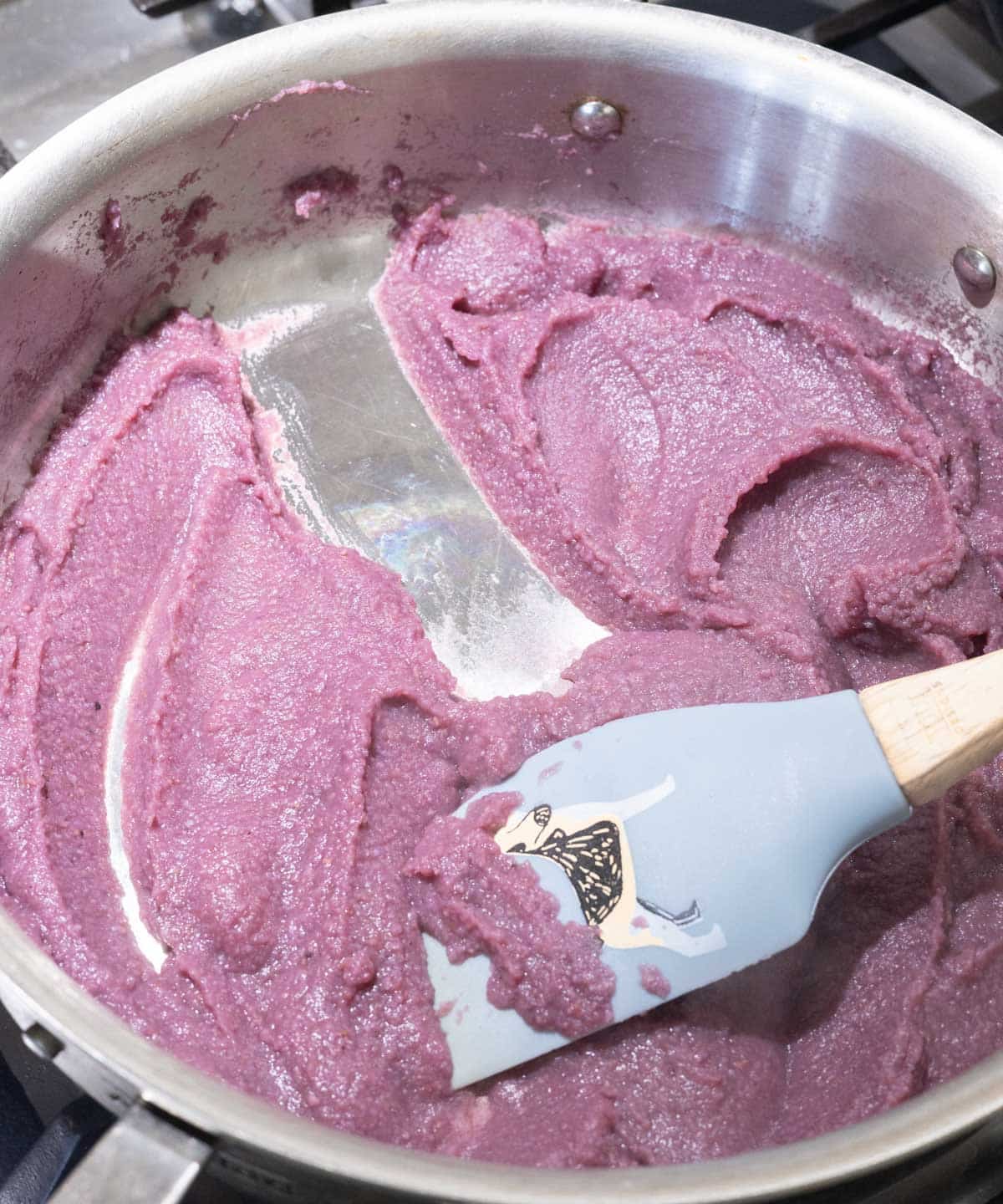 Completely cooked and rehydrated ube powder in a stainless steel pan.