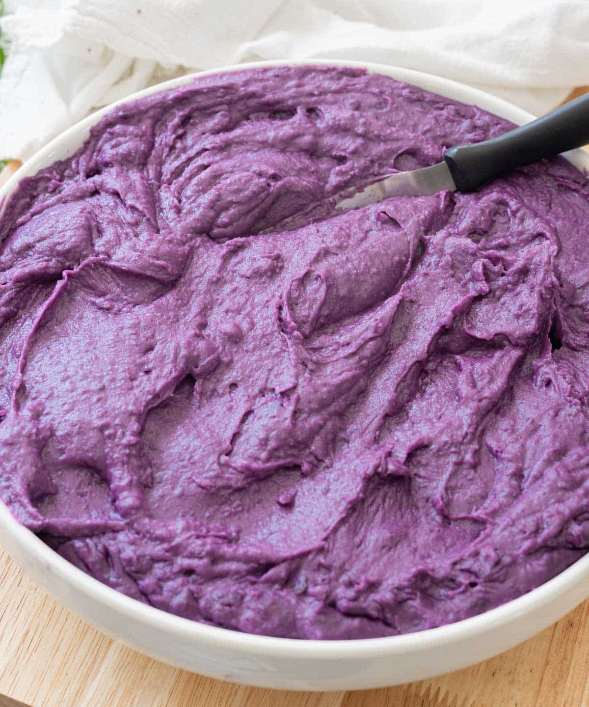 Creamy ube halaya in a large white bowl.