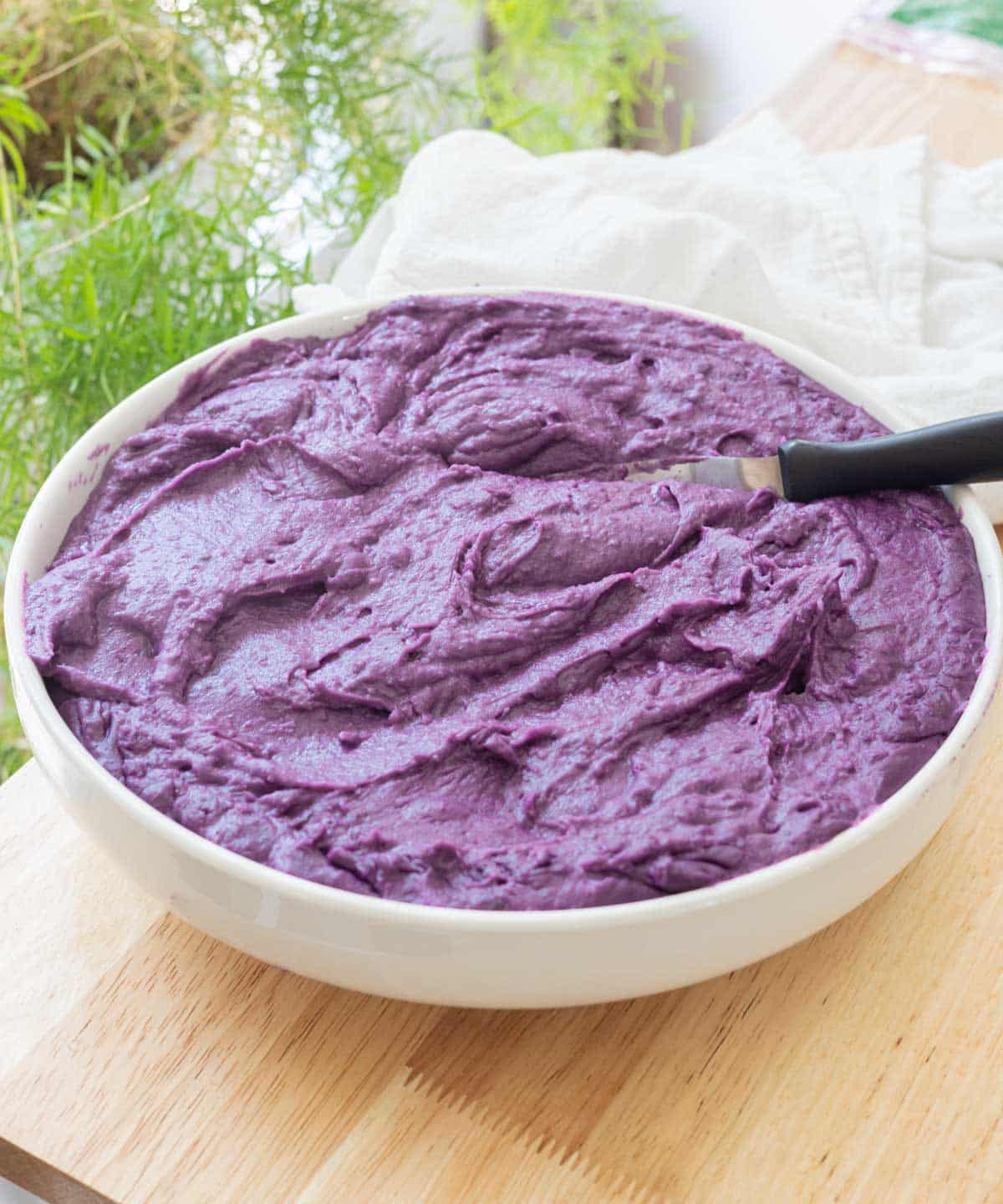 Creamy ube halaya in a large white bowl.