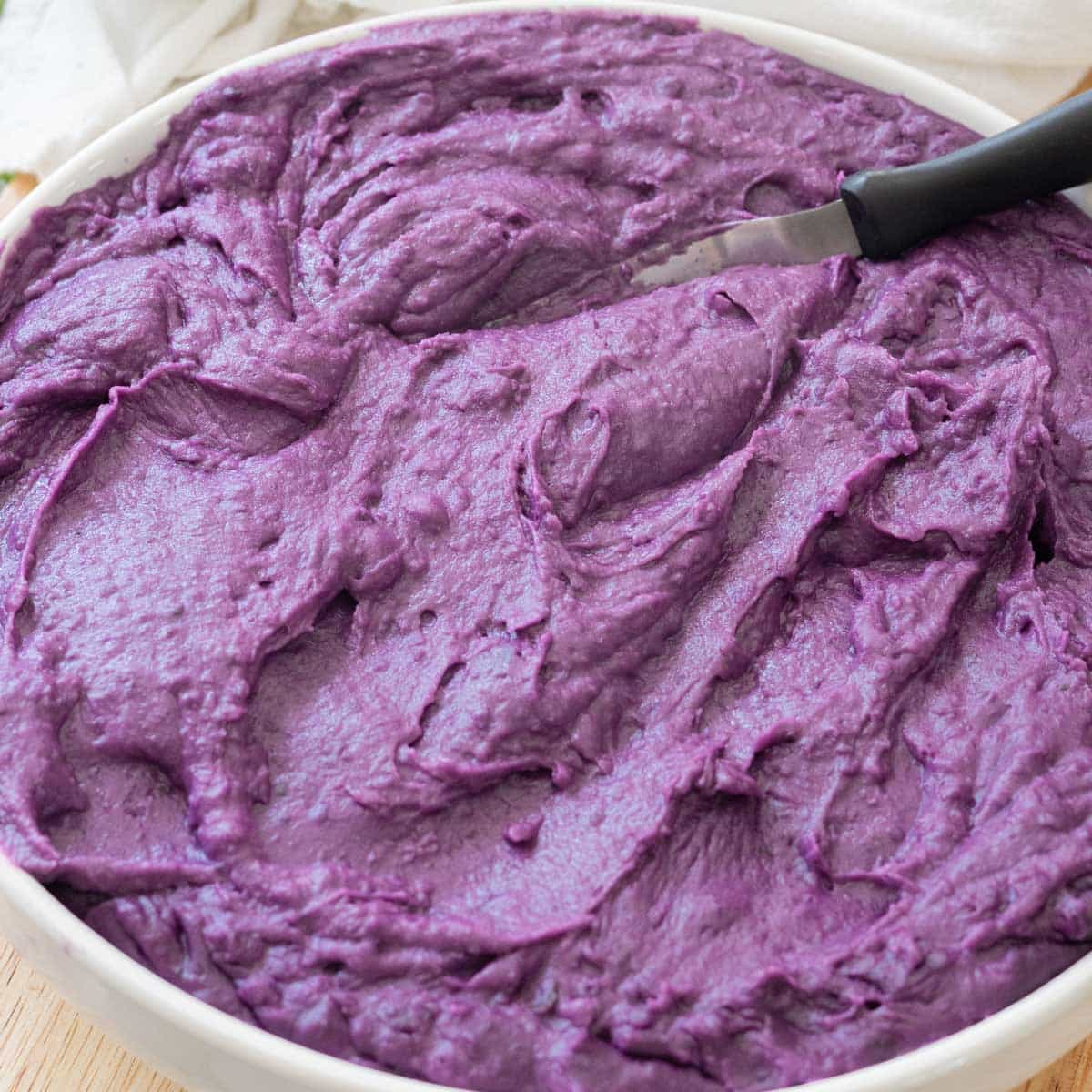 Creamy ube halaya in a large white bowl.