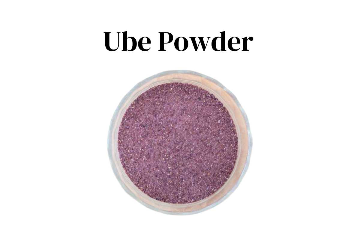 Ube powder in a glass bowl with a white background.