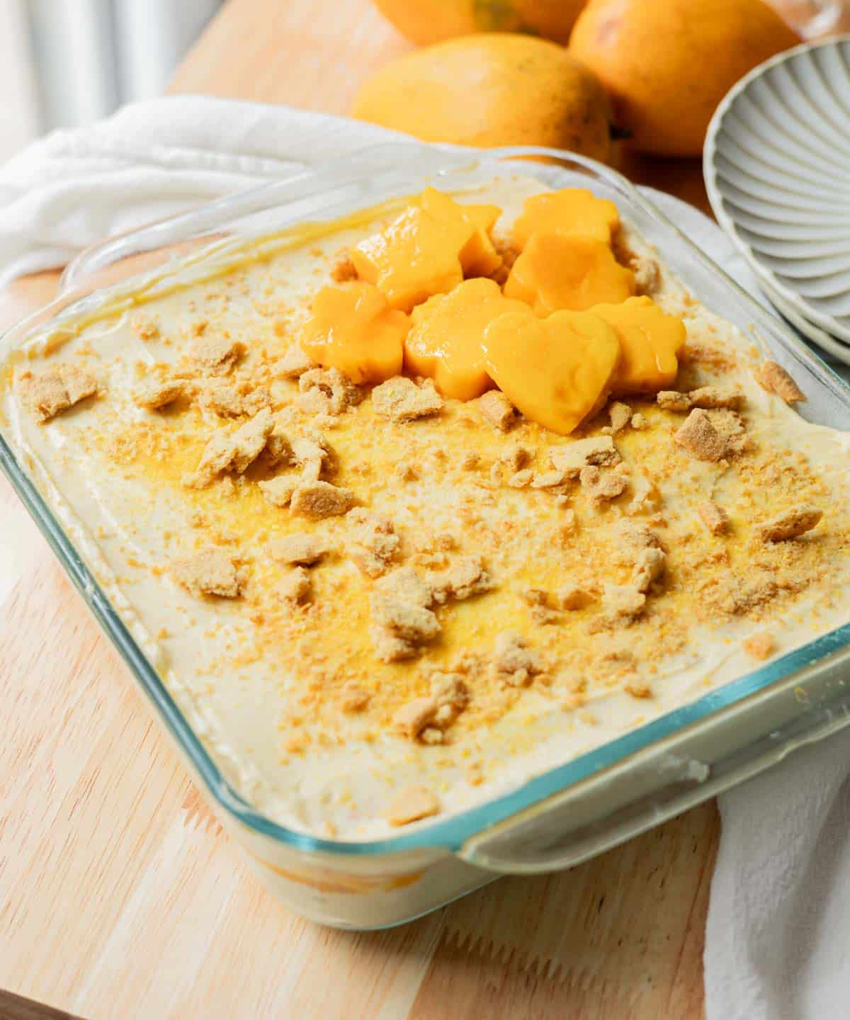 Filipino triple mango float in glass baking dish.