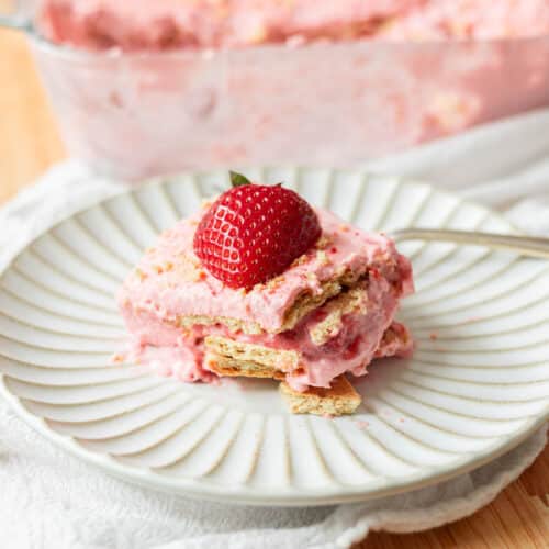 Triple strawberry icebox cake on a white fluted plate.