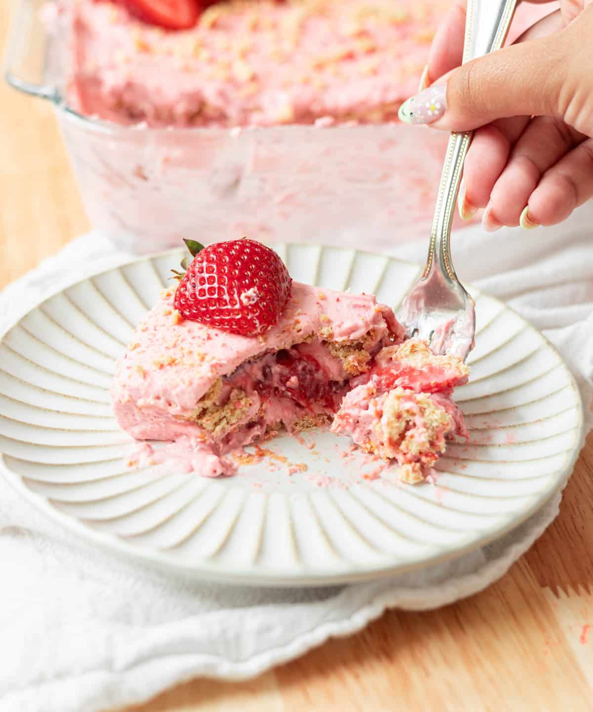 Using a fork to eat the strawberry icebox cake.