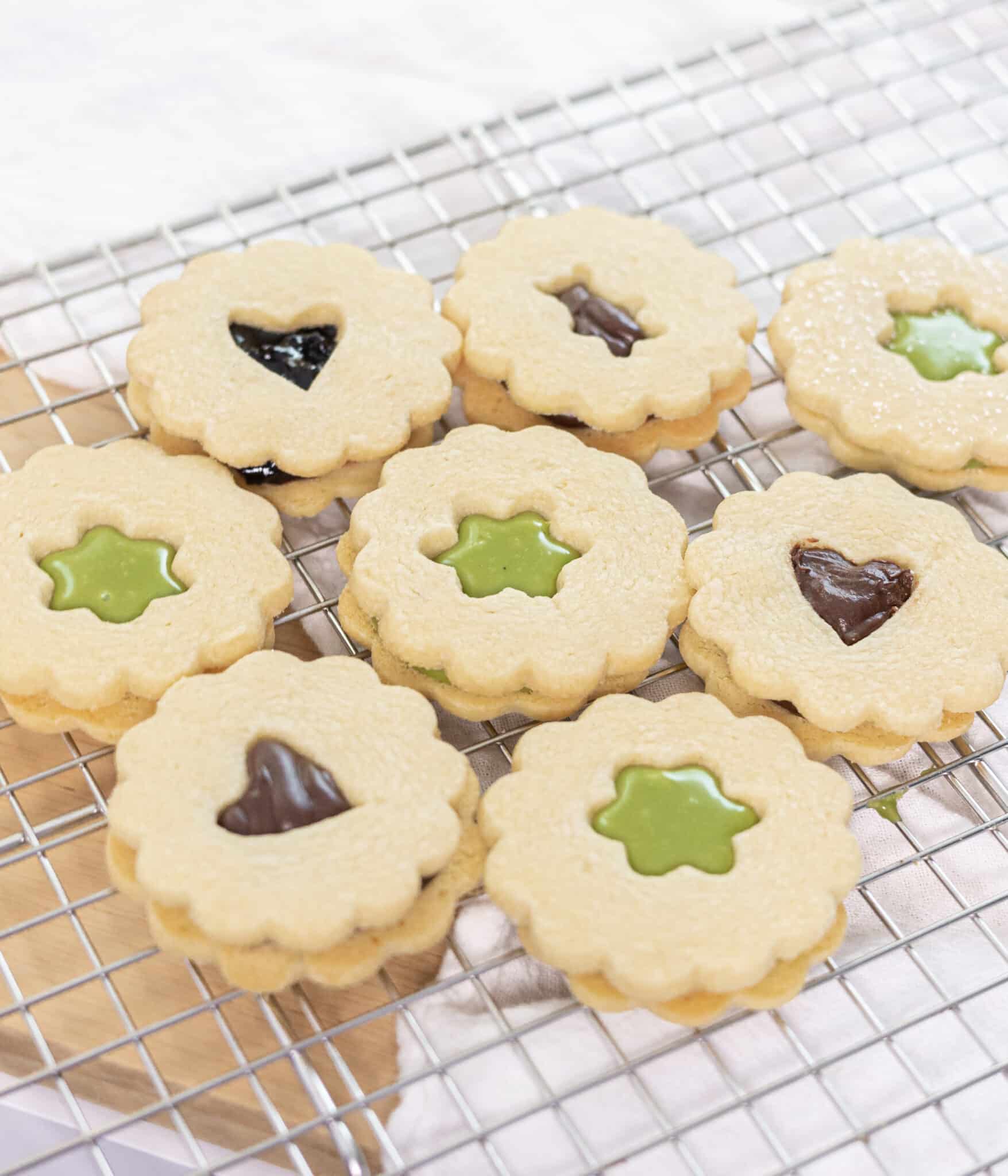 Linzer cookies filled with matcha ganache, chocolate ganache, or jelly.