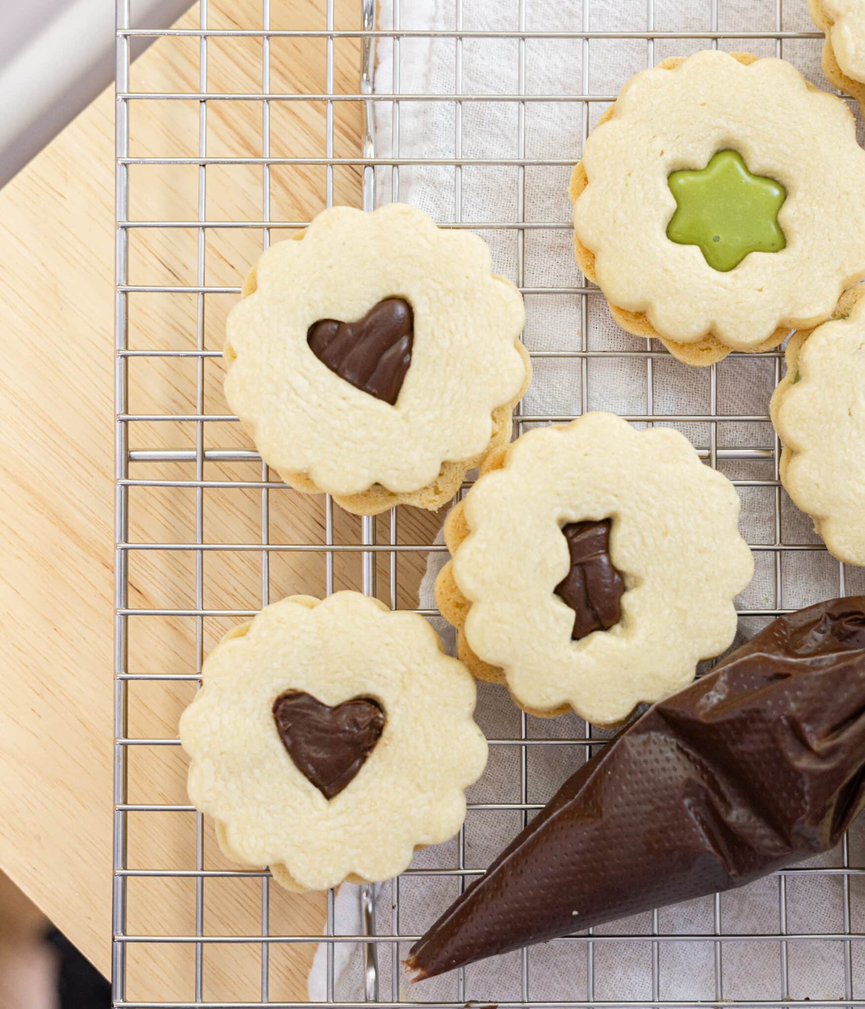 Linzer cookies filled with chocolate ganache and matcha ganache.