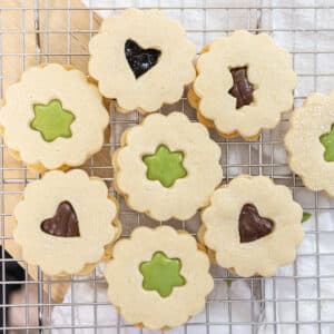 Cute cut-out linzer cookies filled with matcha ganache, chocolate ganache, or jam.