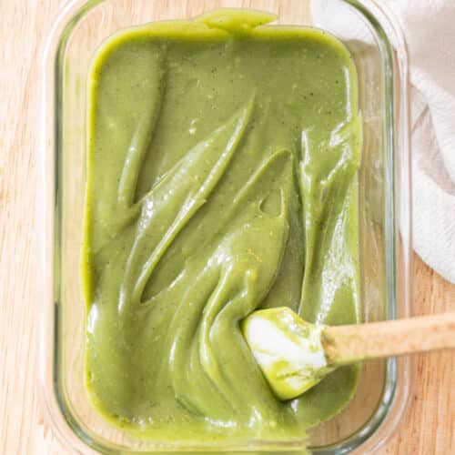 White chocolate matcha ganache in a glass container.