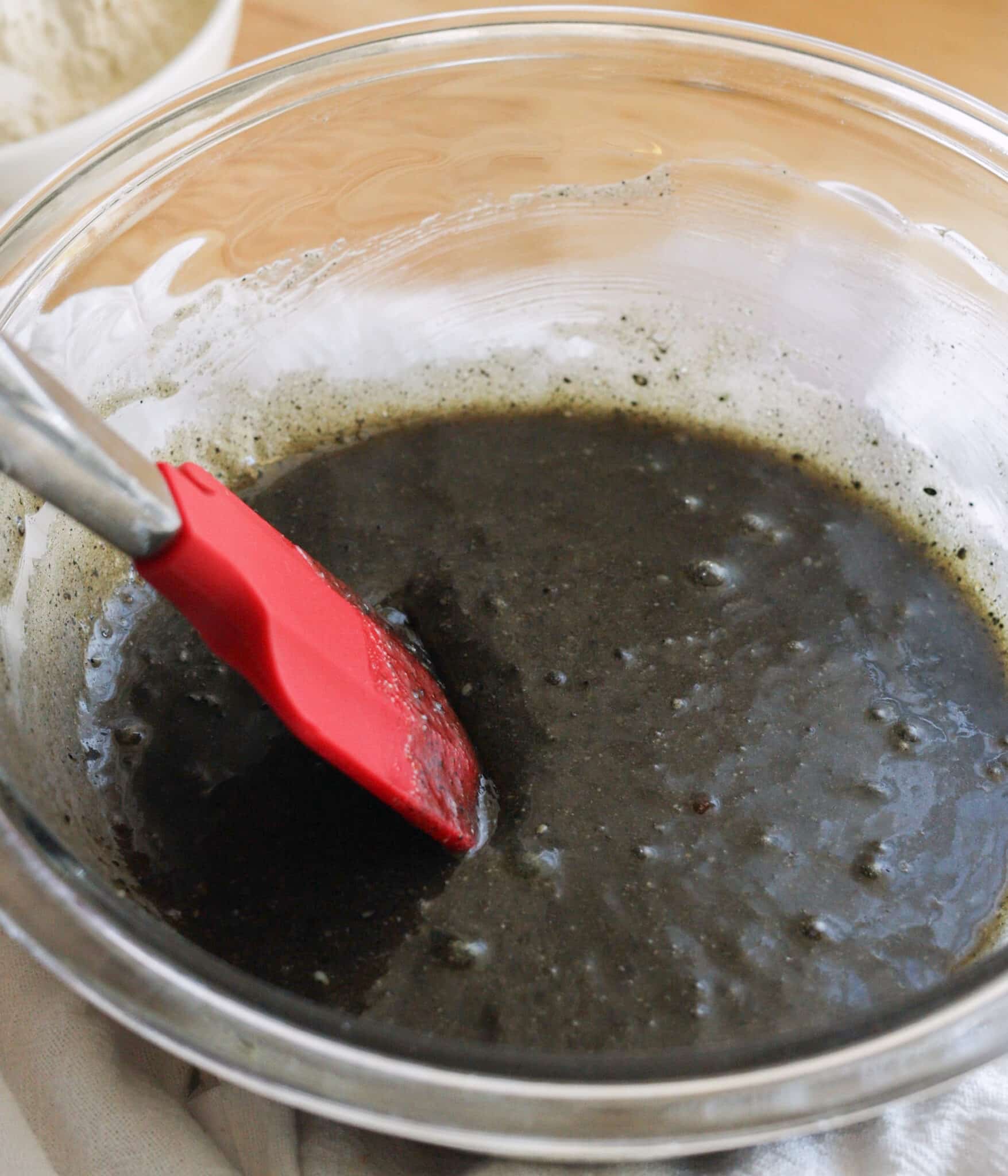 Mixed wet ingredients in a glass bowl.
