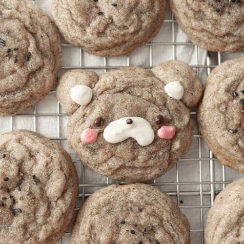 Cute black sesame sugar cookies lined up on a wire rack.