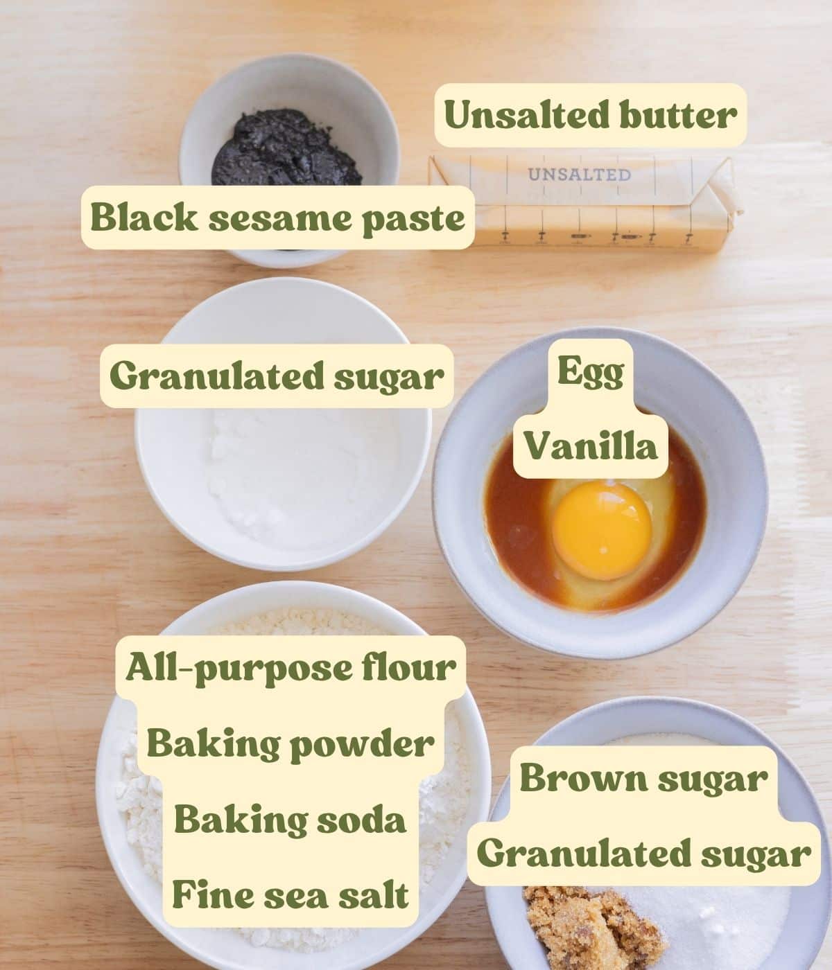 Labeled black sesame cookie ingredients laid out on a table.