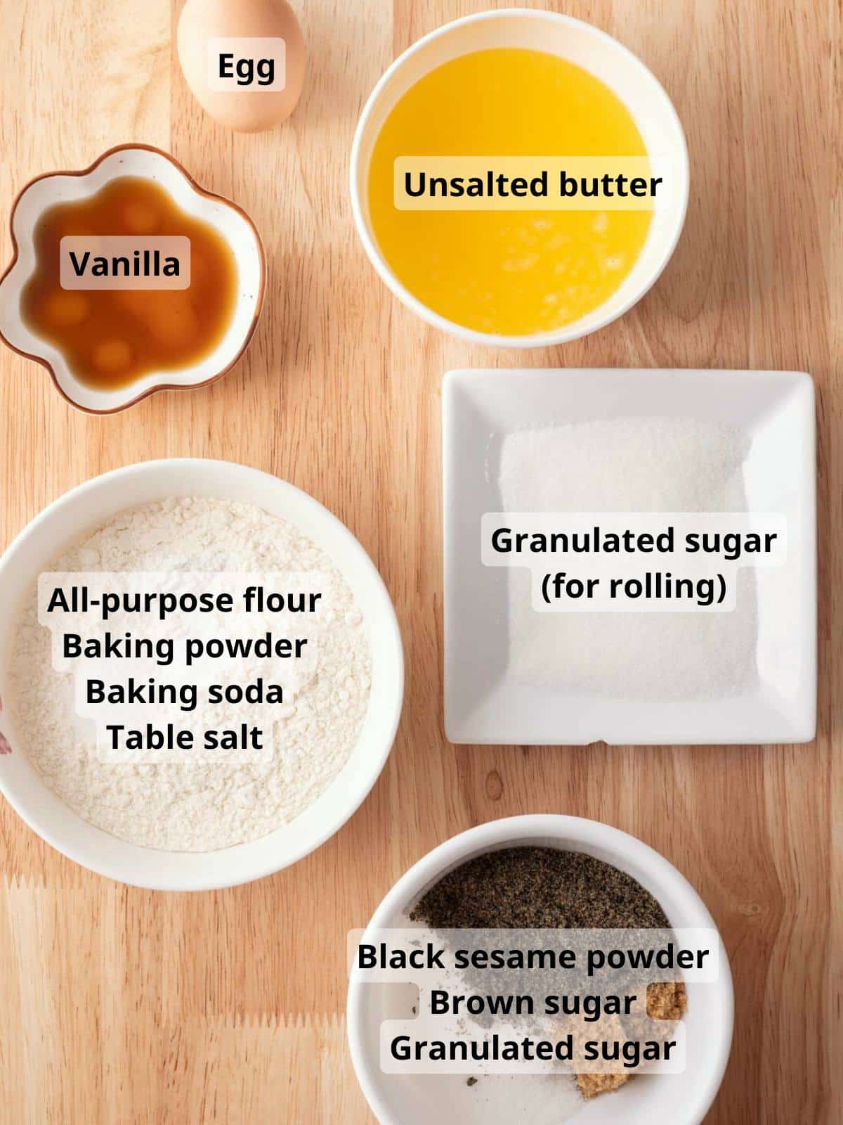 Labeled black sesame cookie ingredients laid out on a table.