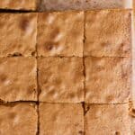 Freshly cut blondies on top of parchment paper.