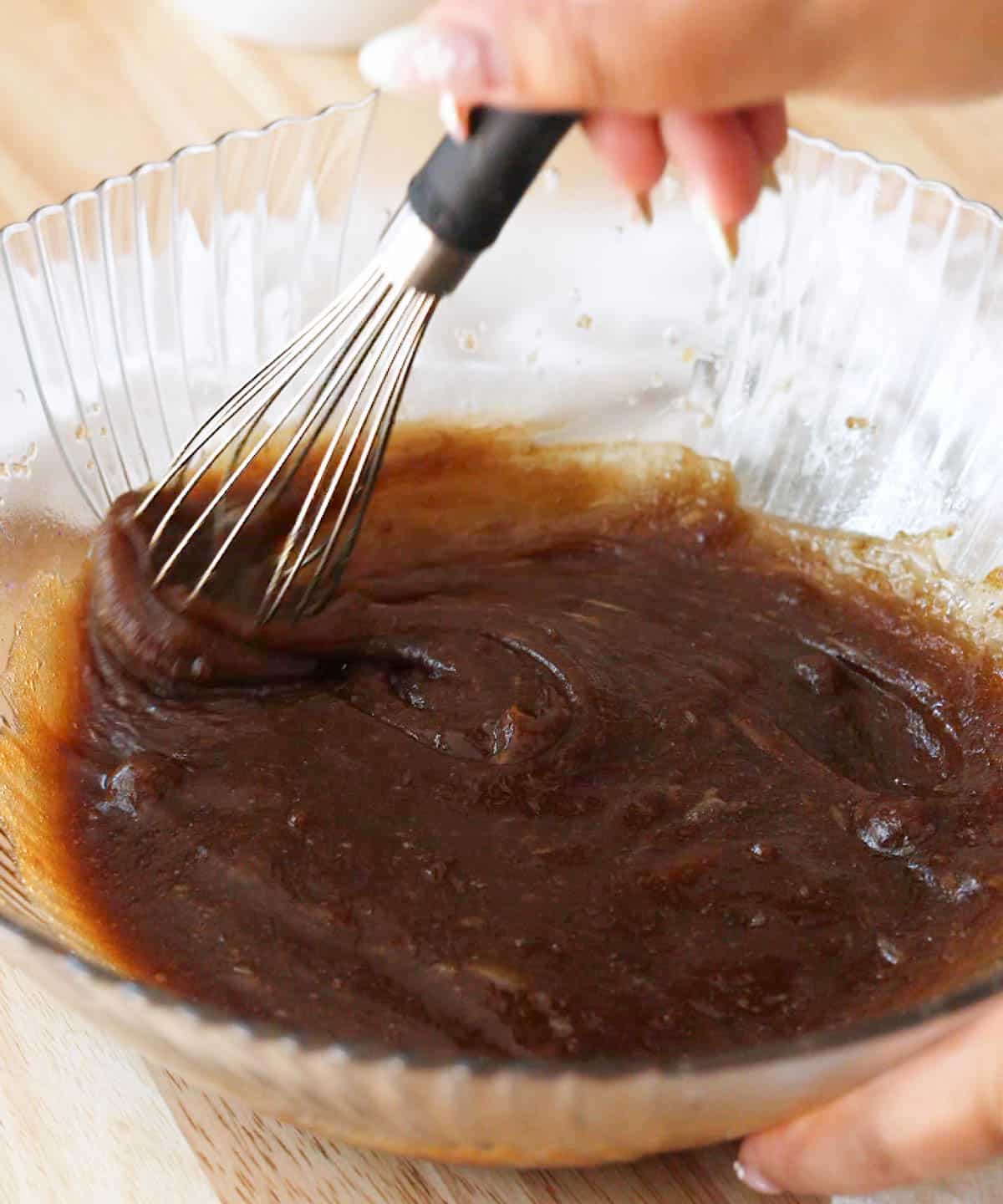 Glass mixing bowl with blondie wet ingredients fully combined.