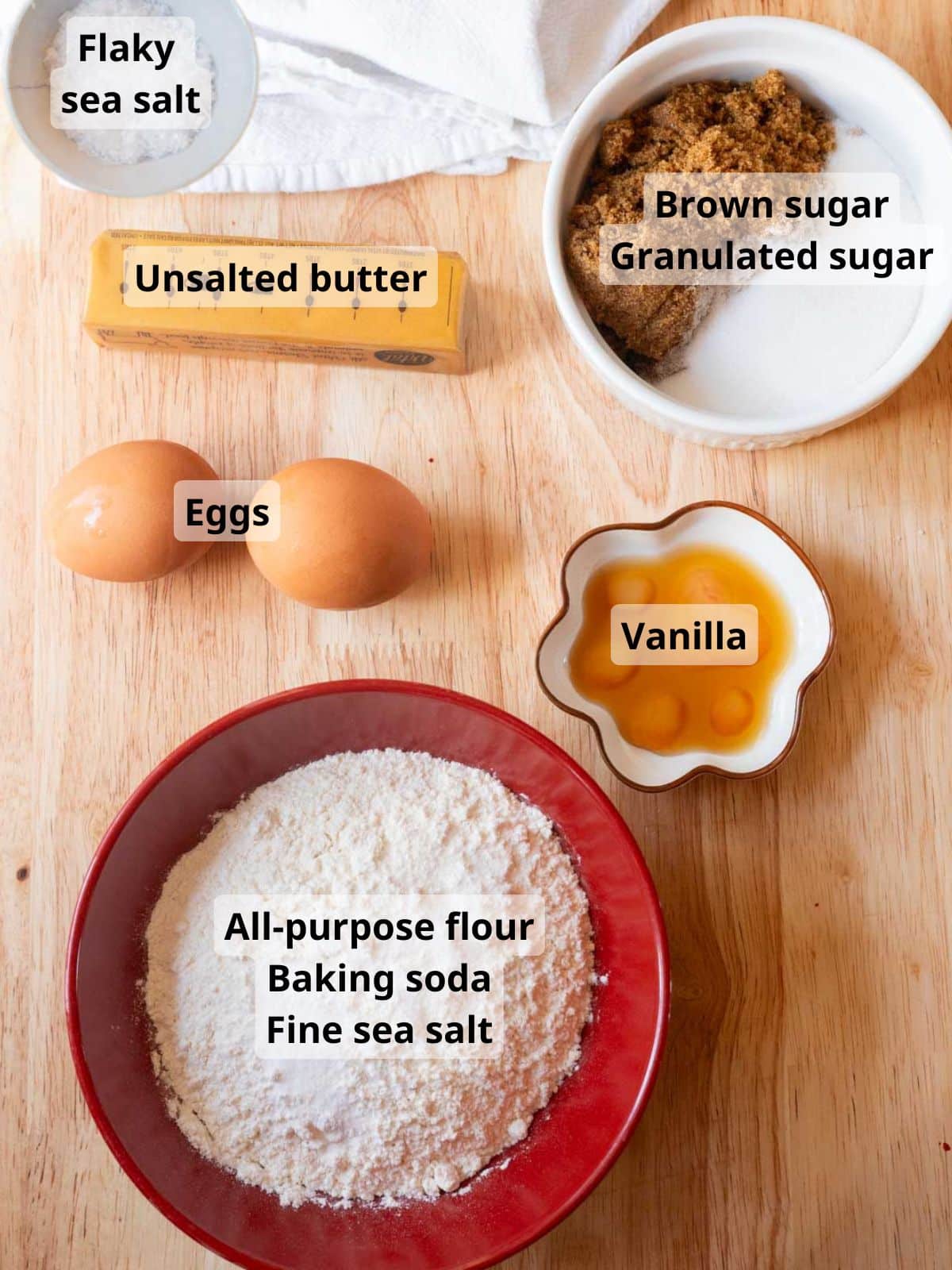 Chocolate chipless cookie labeled ingredients on a wooden table.