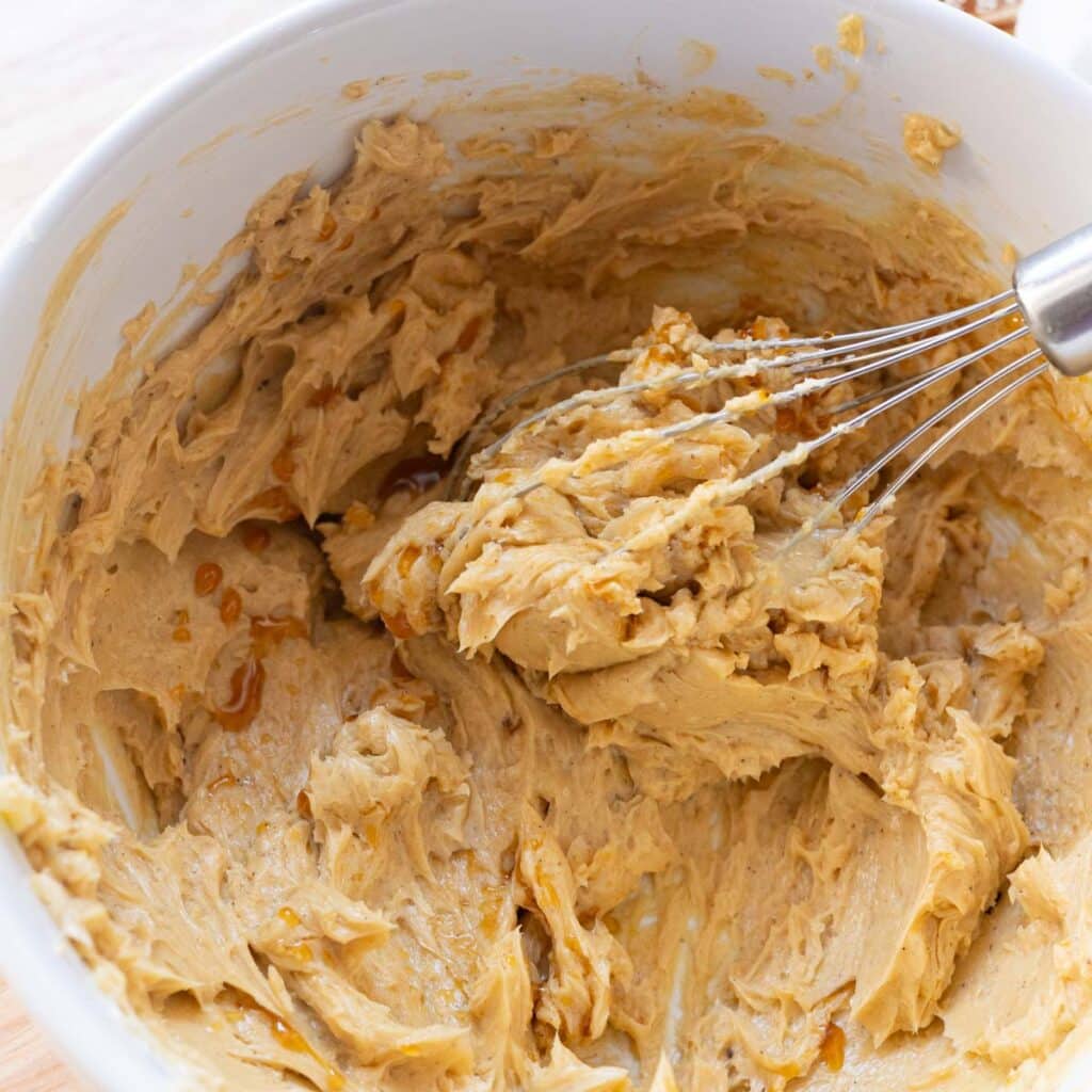 Homemade brown sugar maple butter in a white mixing bowl.