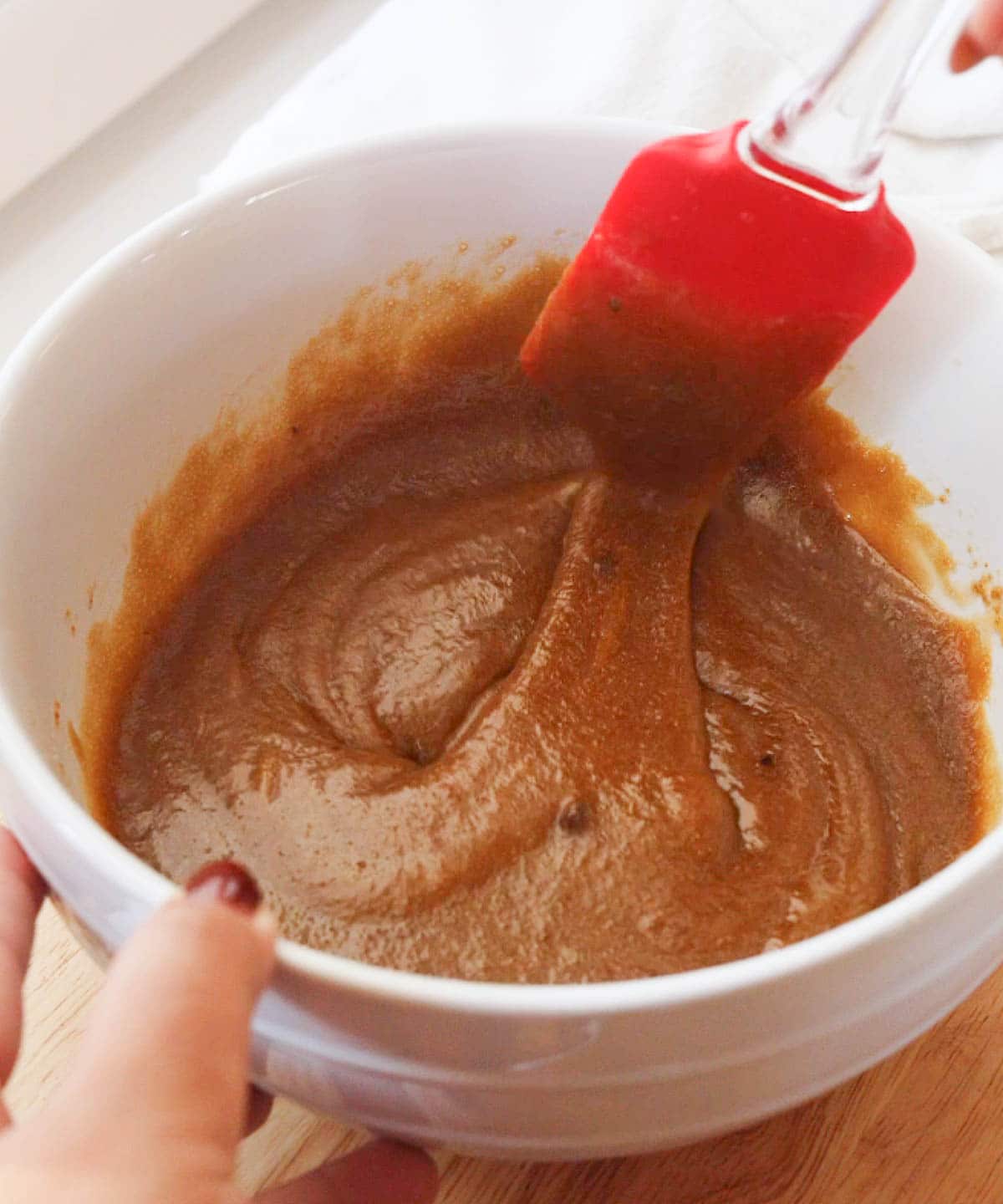 Wet ingredients mixed in white mixing bowl.