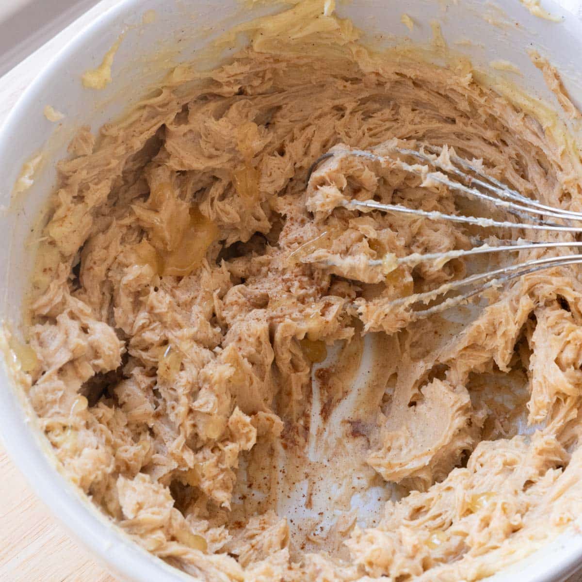 Homemade cinnamon honey butter in a white mixing bowl.