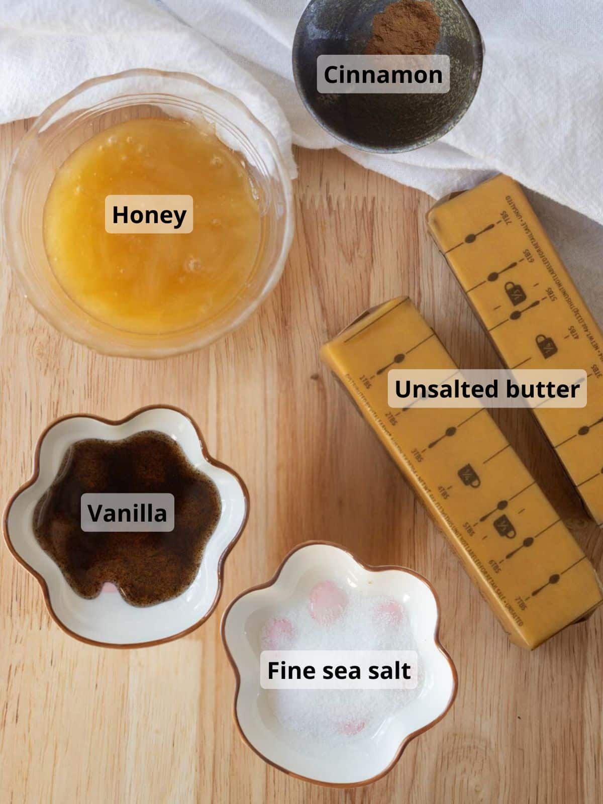 Labeled cinnamon honey butter ingredients on a wooden table.