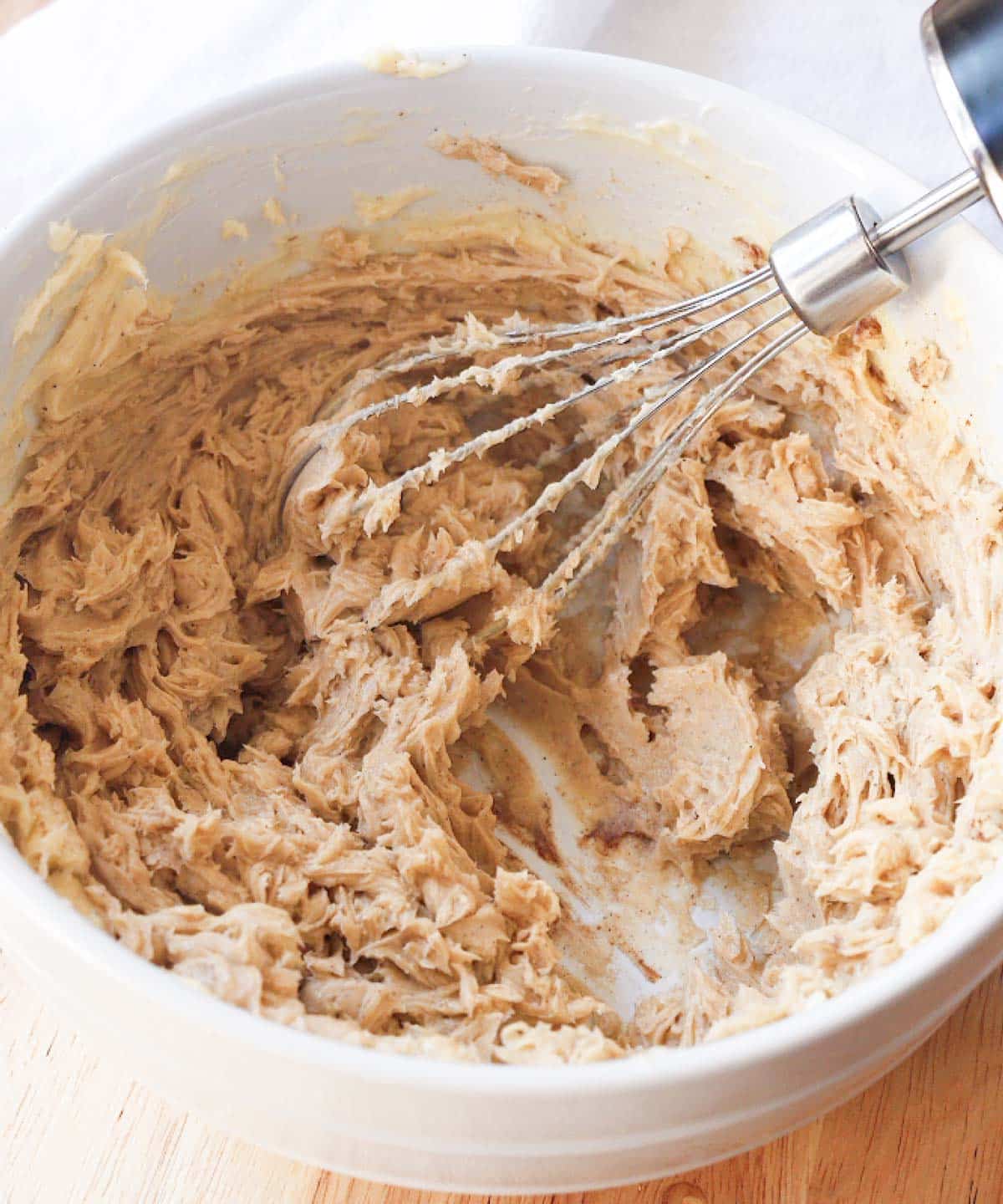 Mixing in cinnamon, honey, vanilla, and salt into whipped butter.