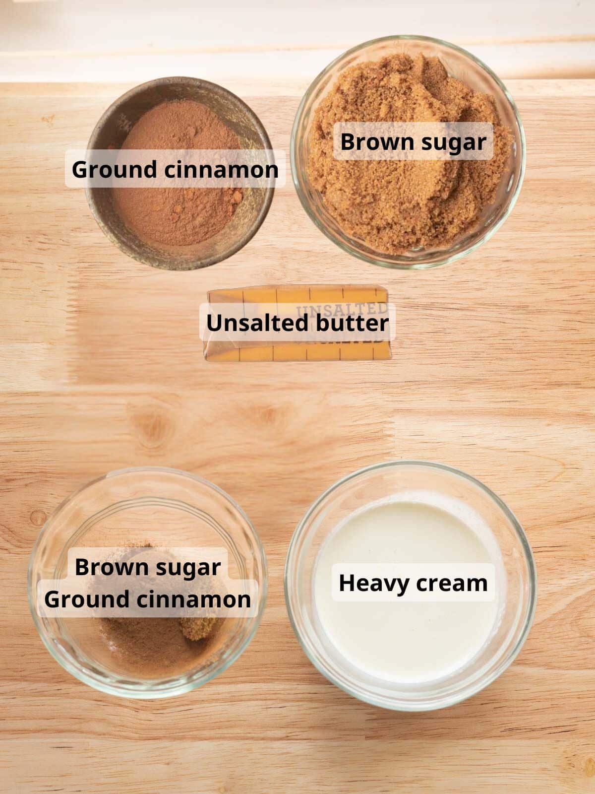 Labeled cinnamon roll filling and heavy cream sauce ingredients laid out on a table.